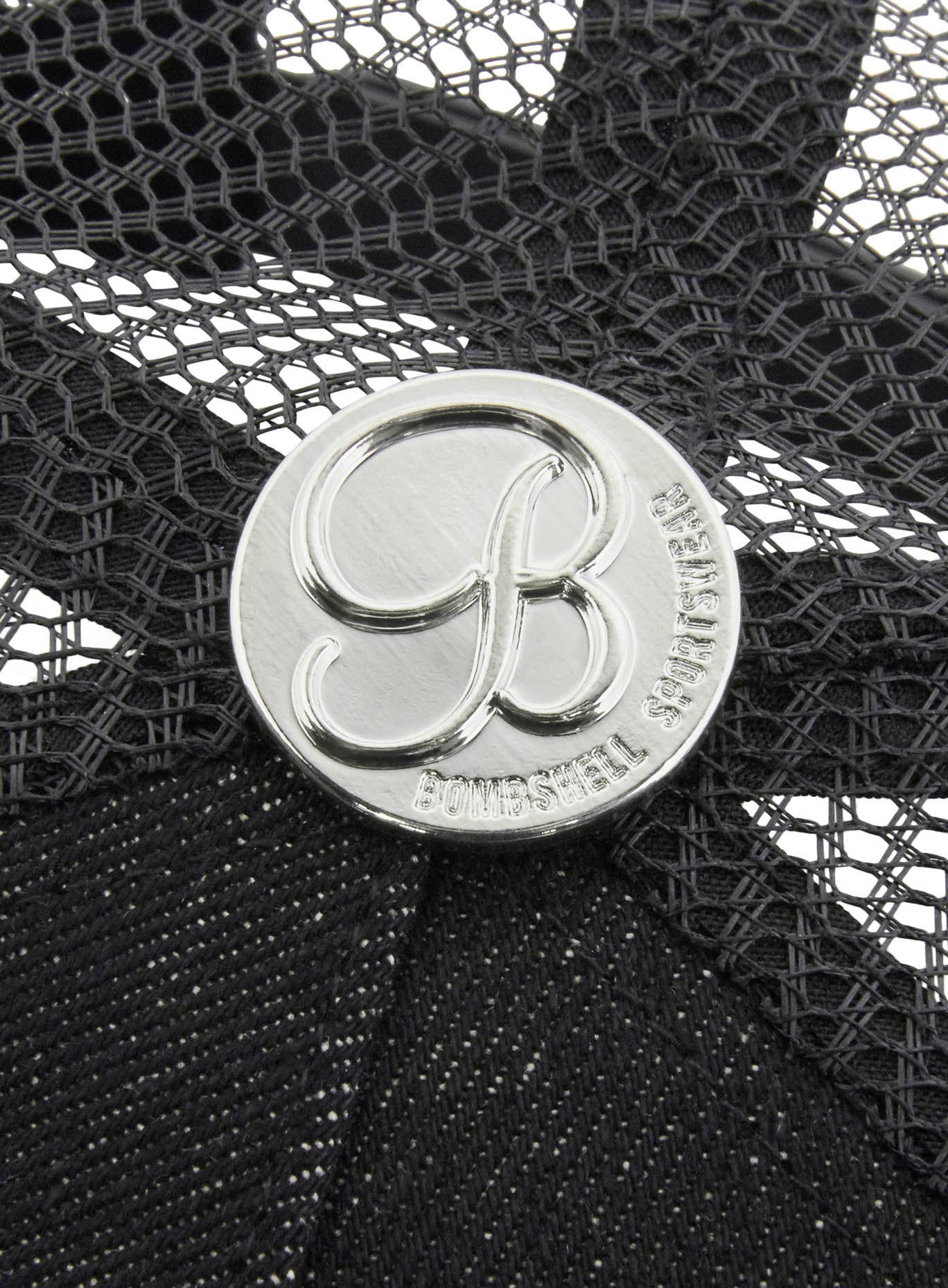 Silver Bombshell logo hardware on the back of a black Denim Crocodile Hat with textured finish.