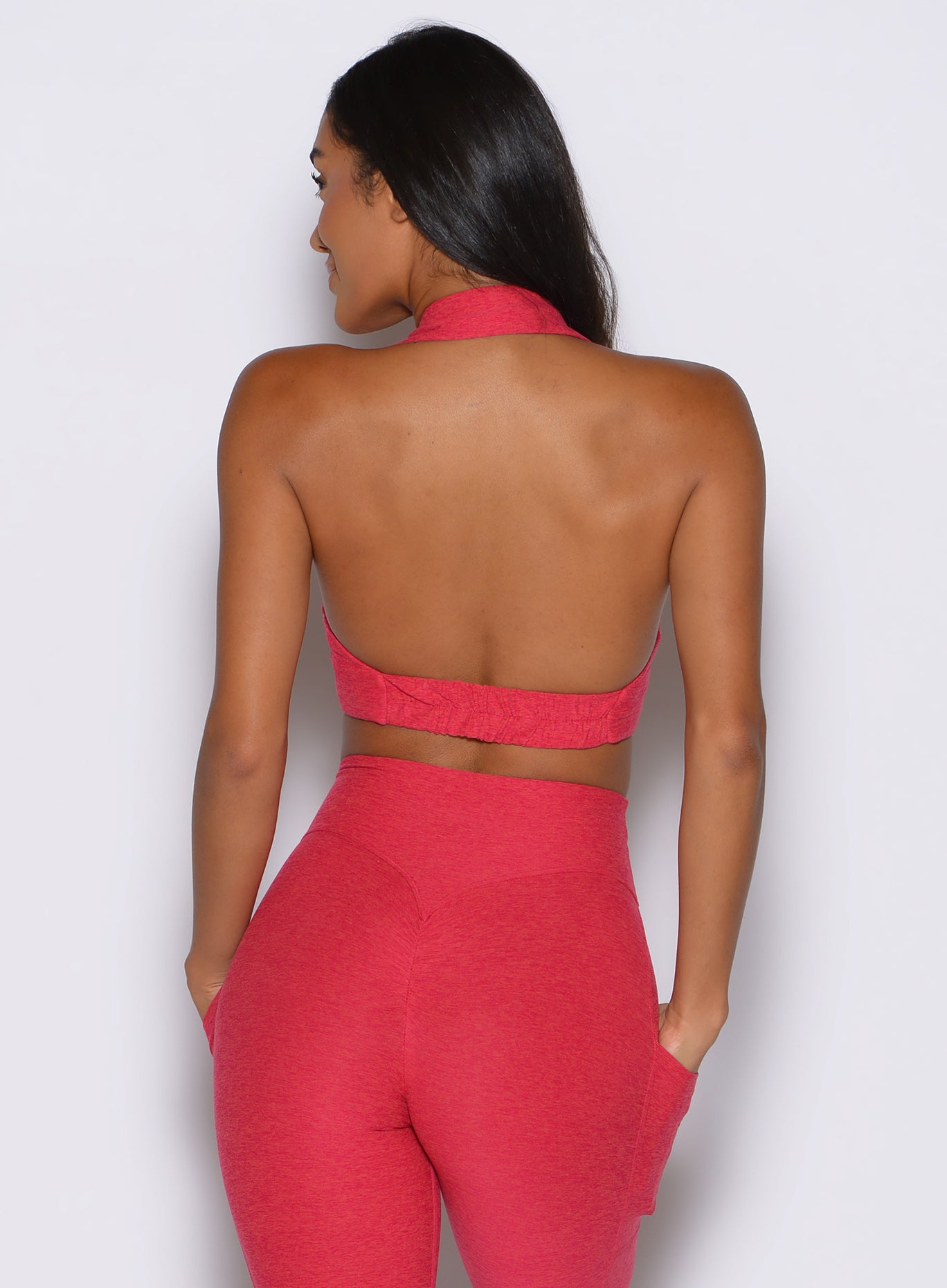 back profile view of a model wearing the Ace Active Top in Victory Ruby color