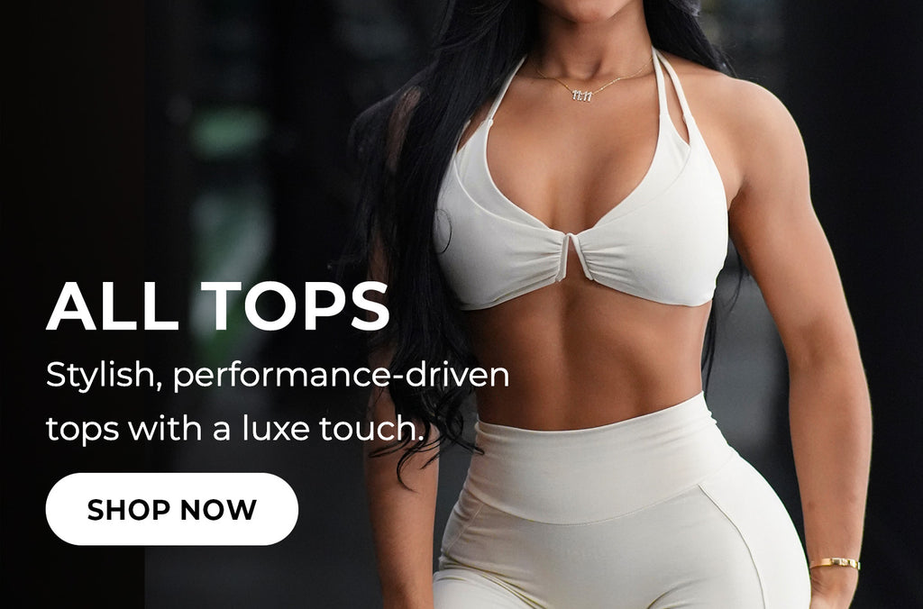 Model wearing a white sports bra and matching shorts. Promotional text reads: "ALL TOPS Stylish, performance driven tops with a luxe touch."