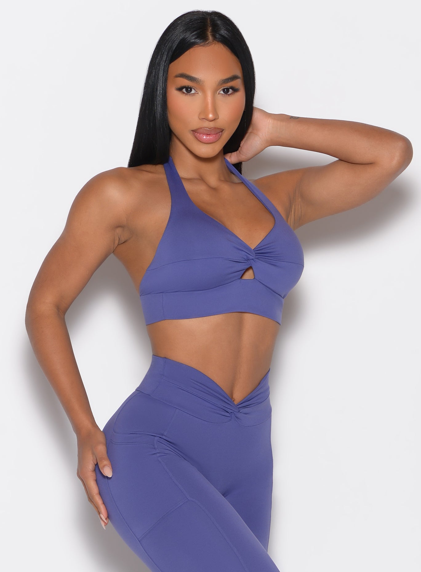 front right side profile view of a model with one hand on her upper thigh wearing the Backless Knot Bra in future dusk color