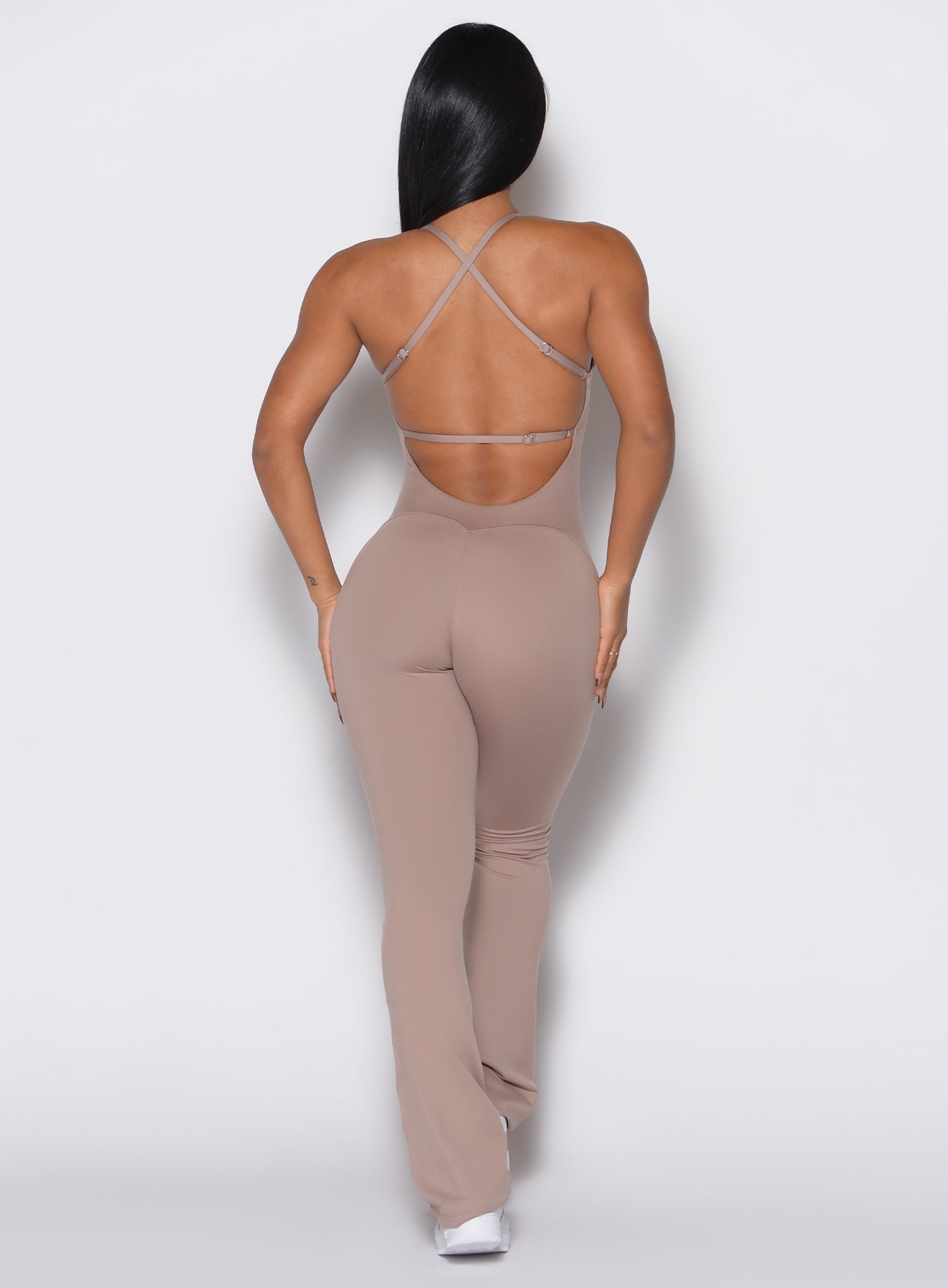 Clay Bombshell Bunny Bodysuit with a flattering open back and flare legs for high-impact workouts.