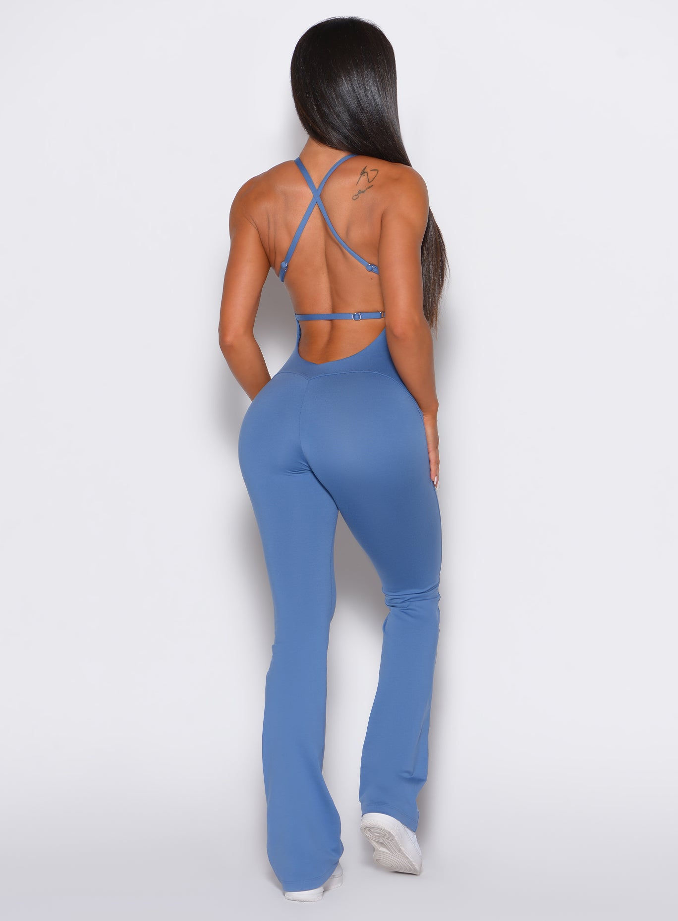 Sculpting Dusty Blue Bombshell Bunny Bodysuit with flattering back seams for gym performance.