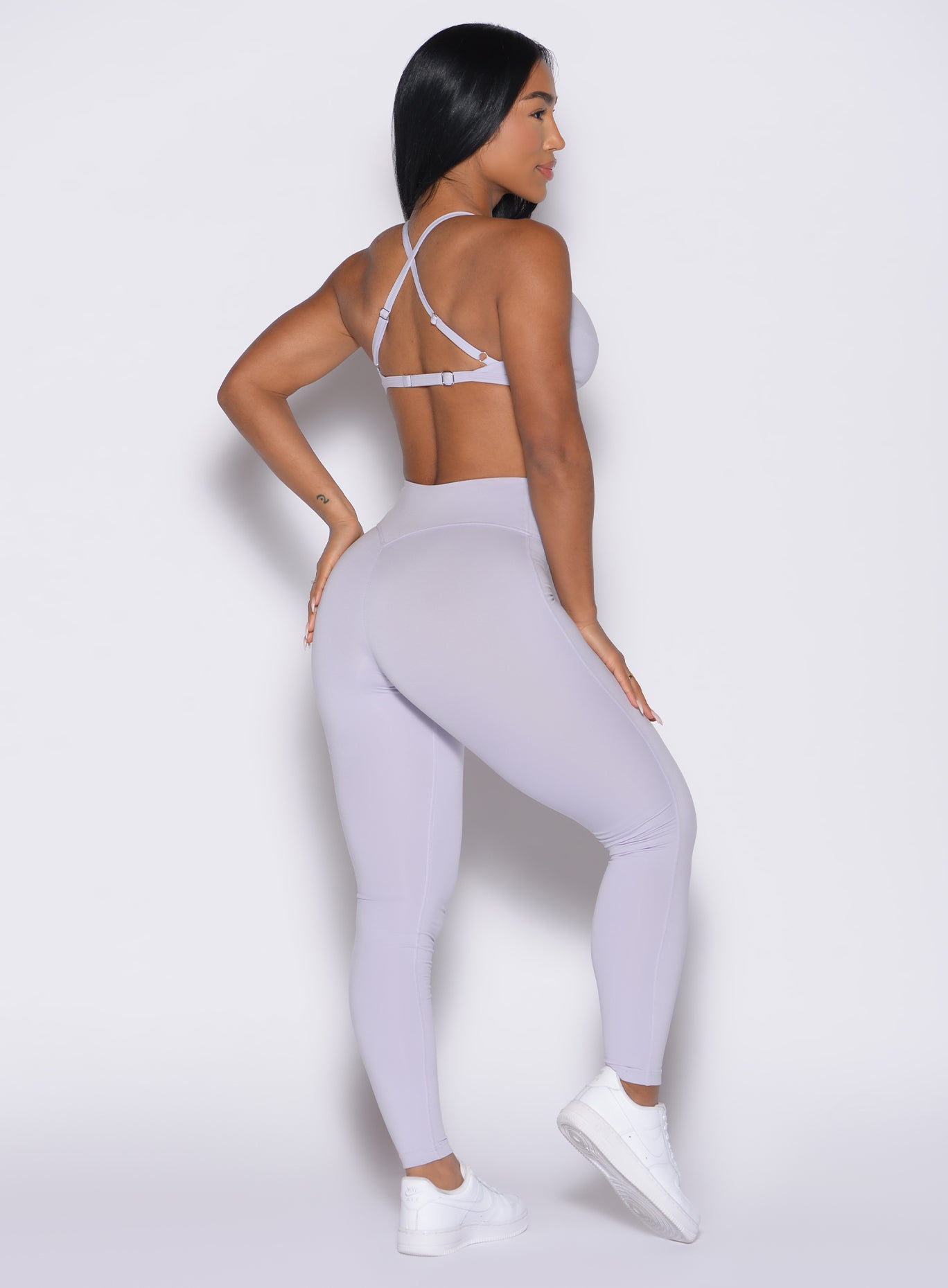 back right side profile view of a model wearing the Bombshell Bunny Leggings in Galactic Lilac color