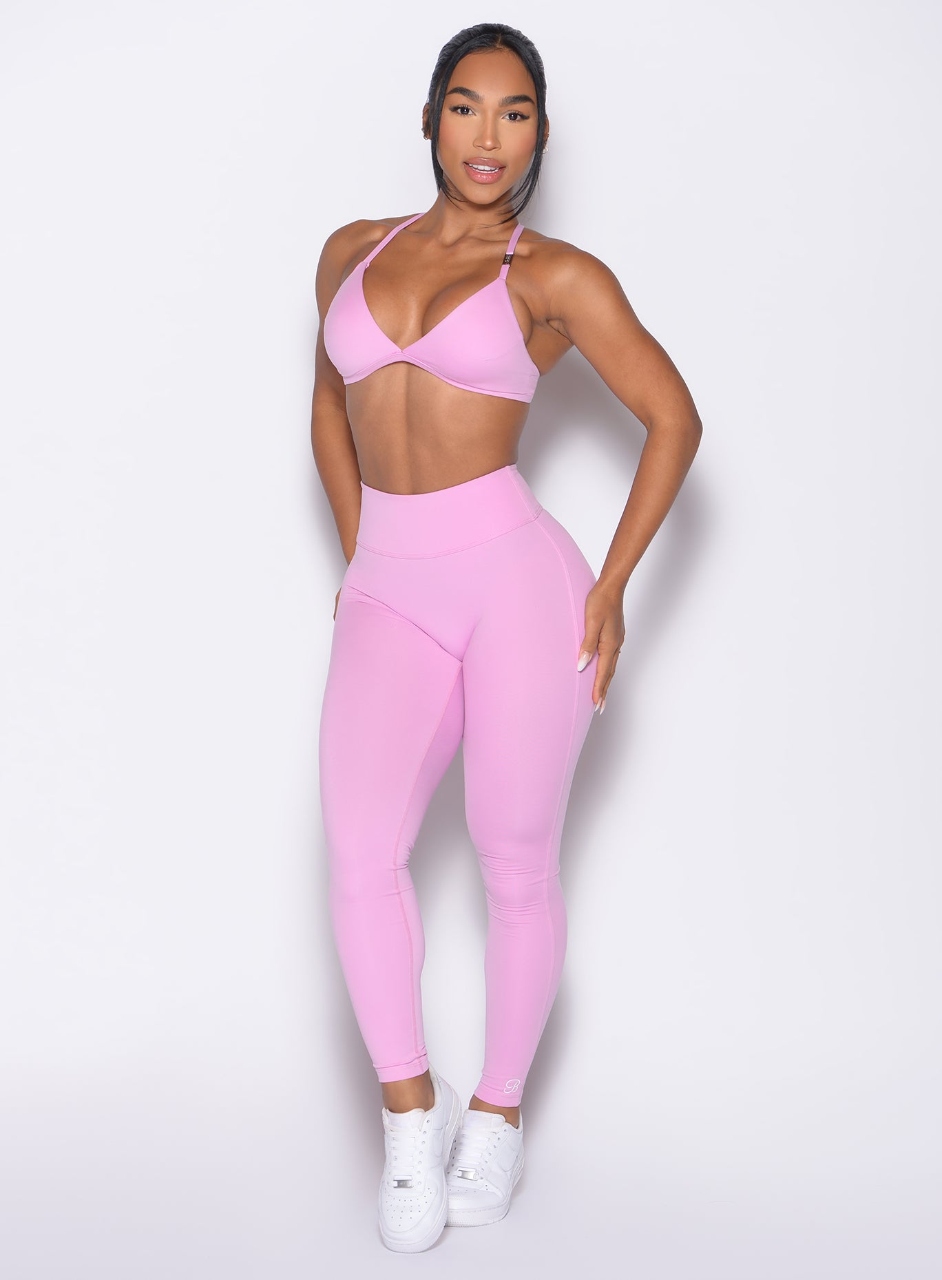 front profile view of a model wearing the Bombshell Bunny Leggings in Lilac Chiffon color paired with the matching bra