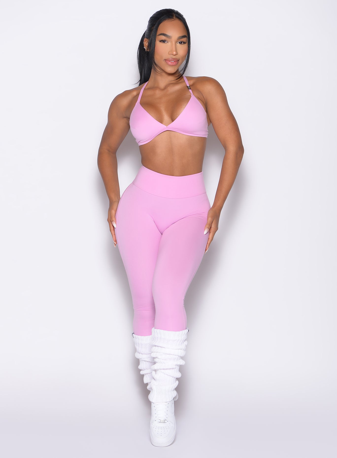 front profile view of a model with both hands on her thighs wearing the Bombshell Bunny Leggings in Lilac Chiffon color