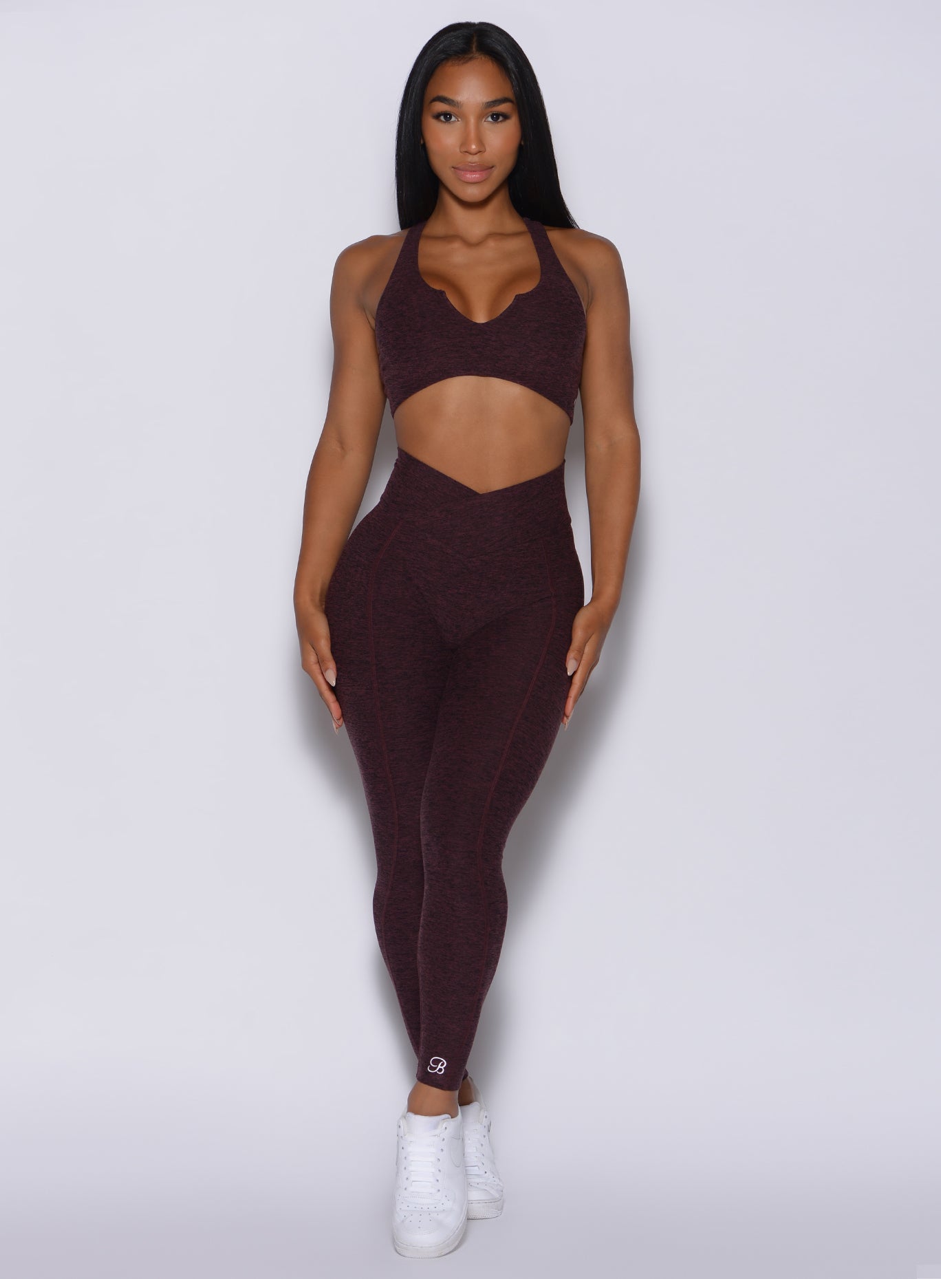 Front profile view of a model in our Brazilian Contour Leggings in port color and a matching bra