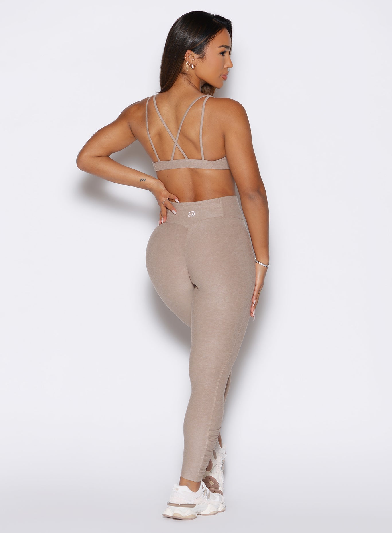Back profile view of Desert Taupe Built Leggings with sculpting booty scrunch and sweetheart seam.