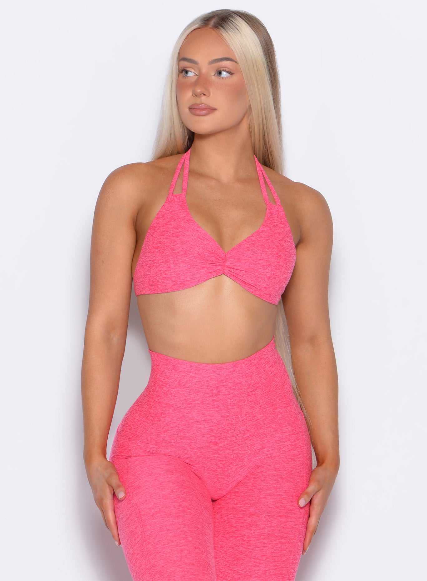 front profile view of our model looking to the right wearing the Butterfly Sports Bra in Neon Flame color