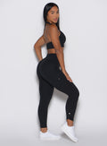 right side profile view of a model wearing the Cargo Edge Leggings in Black color