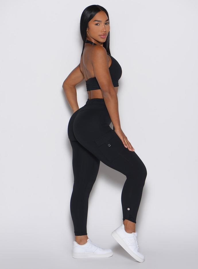 right side profile view of a model wearing the Cargo Edge Leggings in Black color