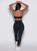 back profile view of a model wearing the Cargo Edge Leggings in Black color