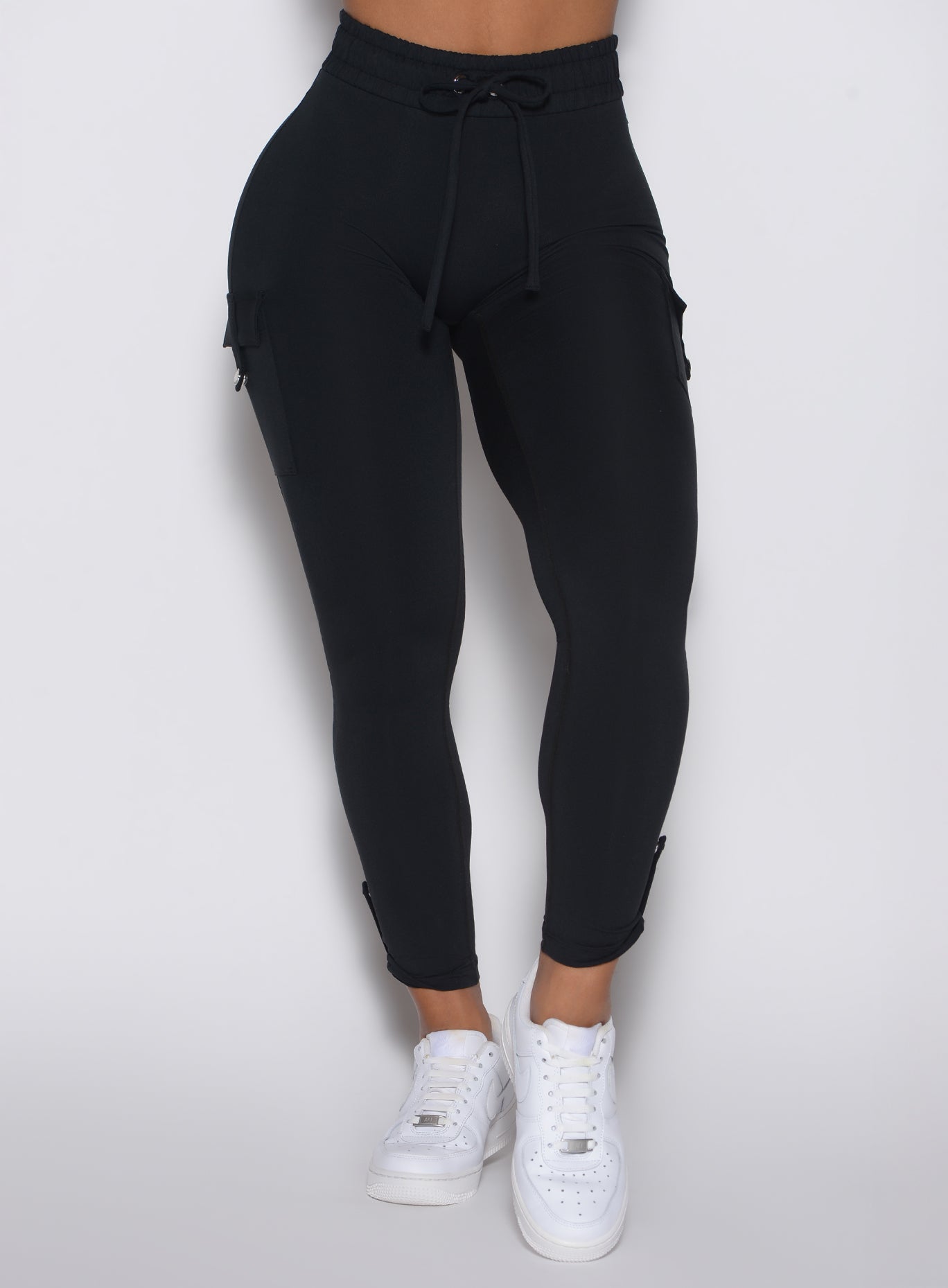 close up front view of a model wearing the Cargo Edge Leggings in Black color