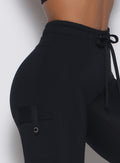 close up right side detailed view of a model wearing the Cargo Edge Leggings in Black color