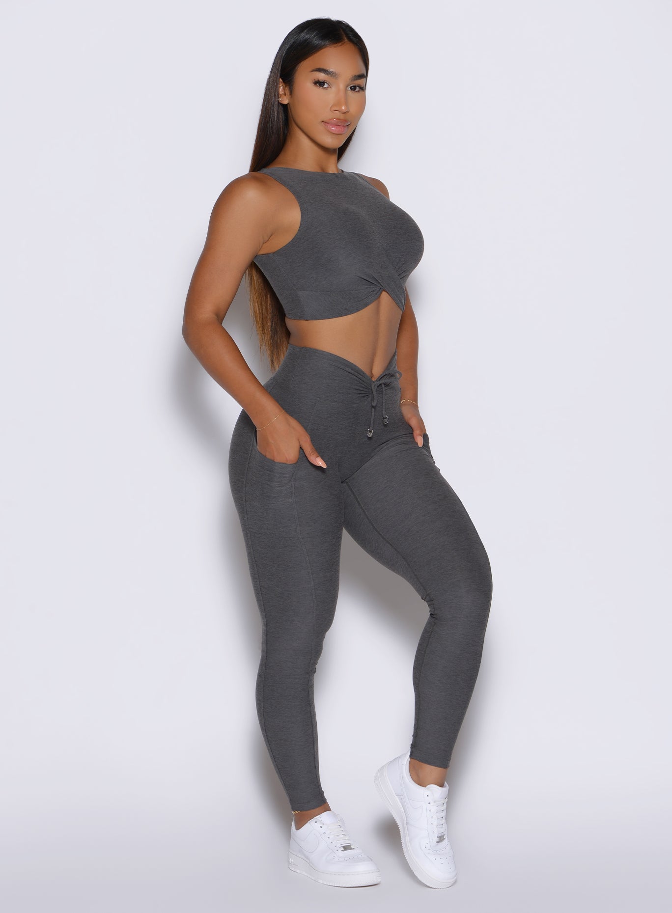 Side view of Steel Shadow Charm Fit Leggings featuring a scrunched V-front and functional side pockets.