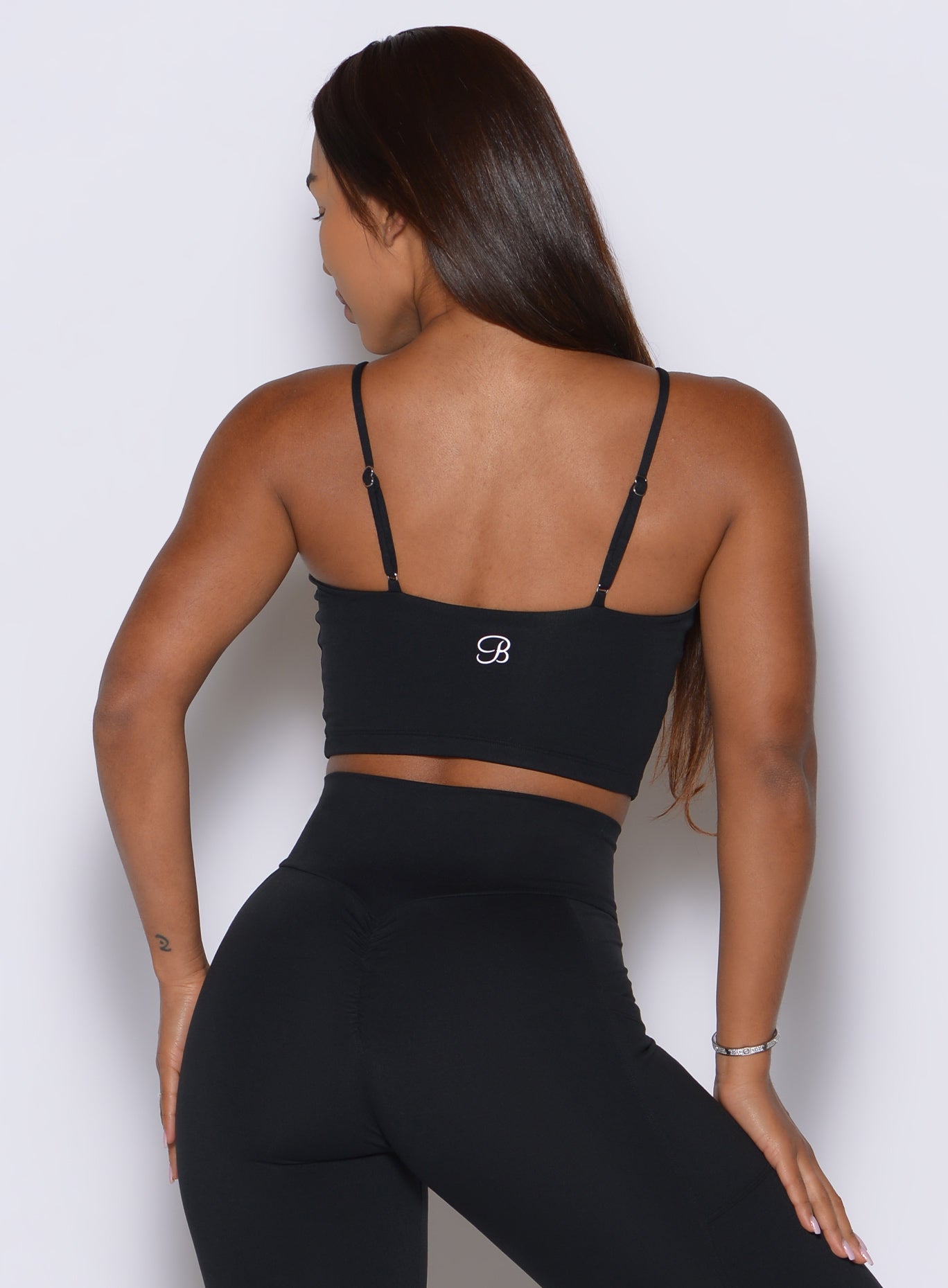 Sleek black cami with adjustable spaghetti straps and a smooth, sculpted back