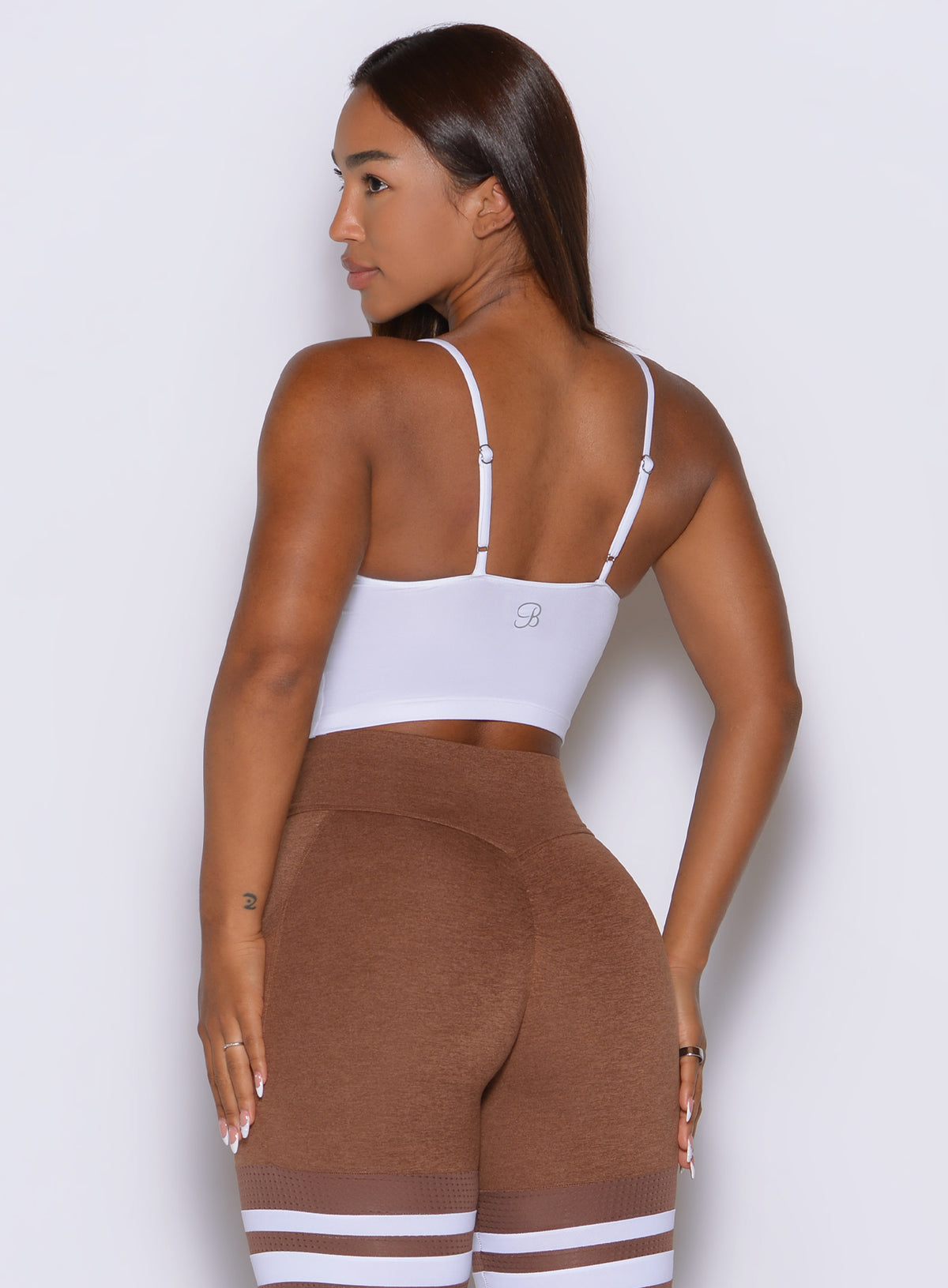 Adjustable spaghetti straps keep the white Cinch Cami Tank sleek and effortlessly minimal