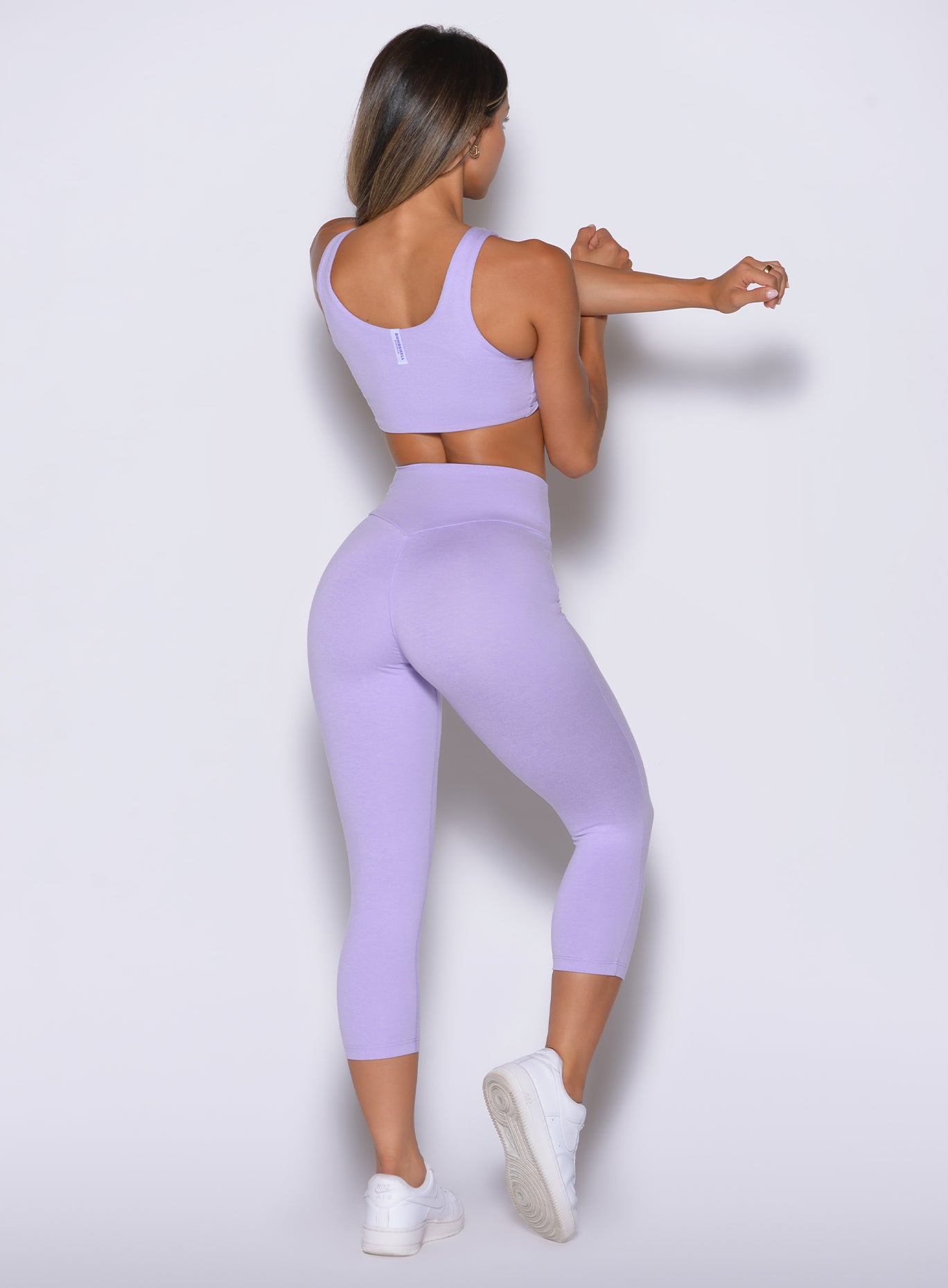 Back right view of Sugared Lilac Contour Capri Leggings featuring curve-molding scrunch lift