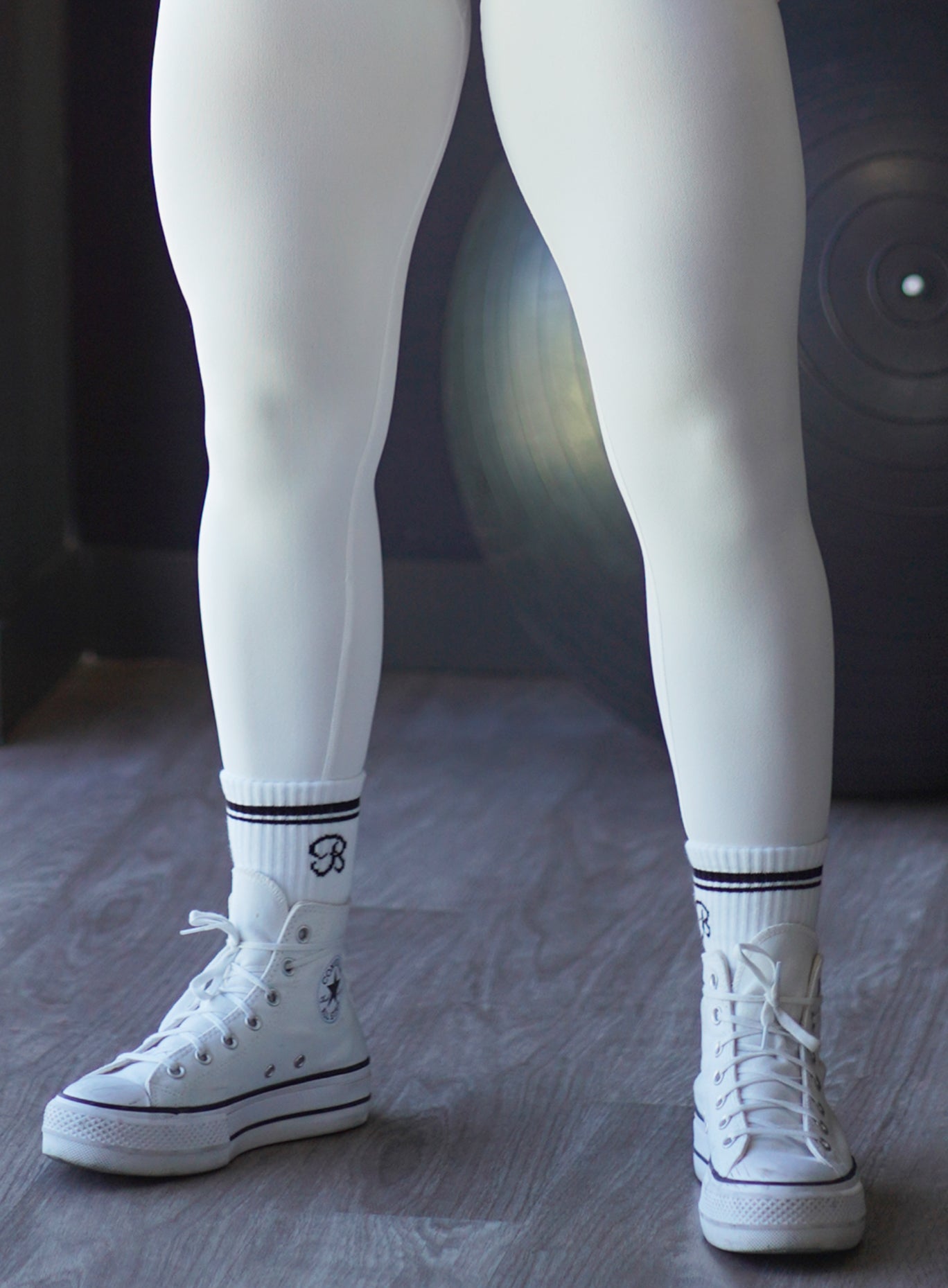 White Crew Socks with bold black stripes and B logo detail, made from breathable cotton.