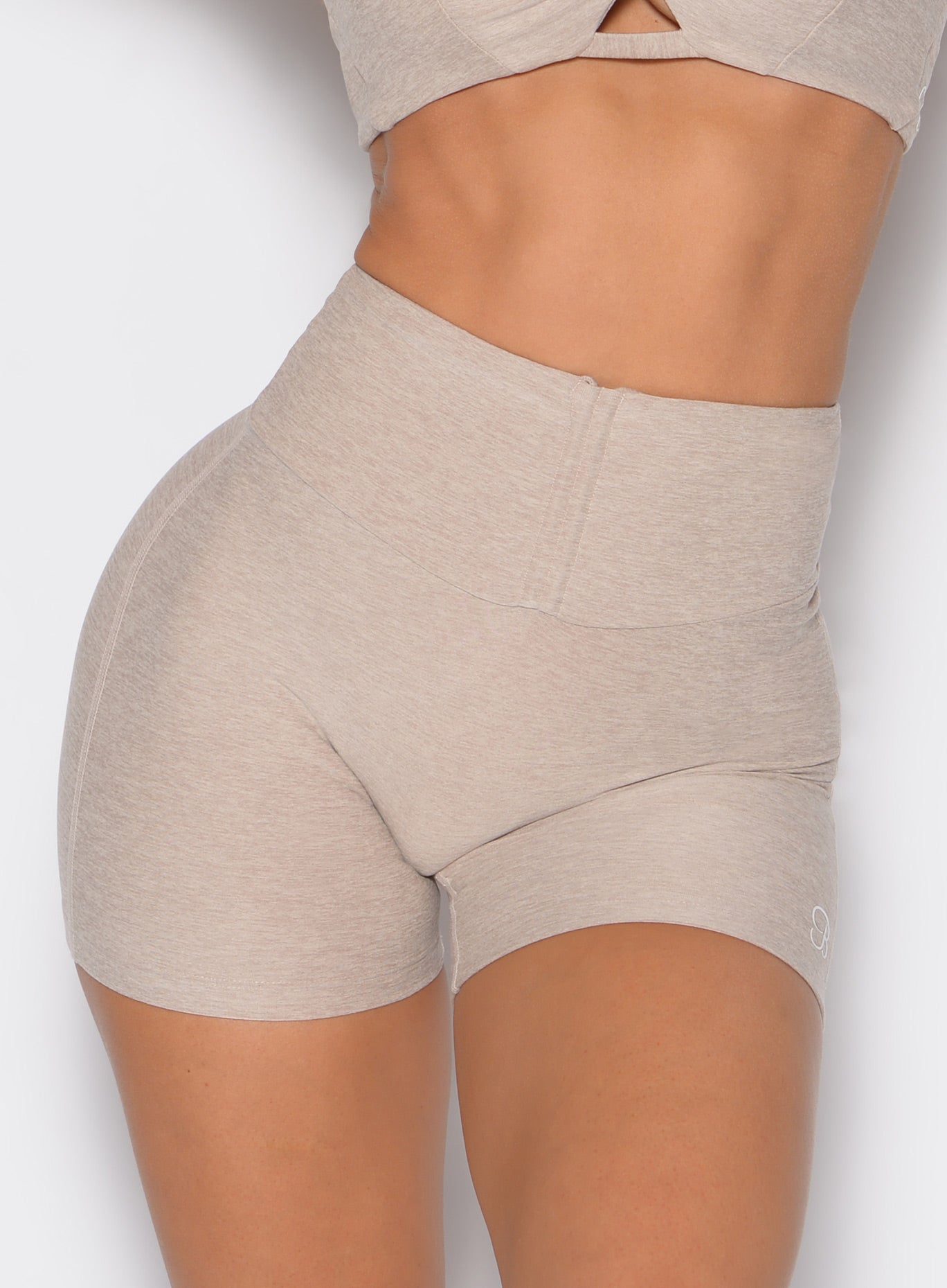 close up front profile shot of a model wearing the Curvemax Shorts in taupe color