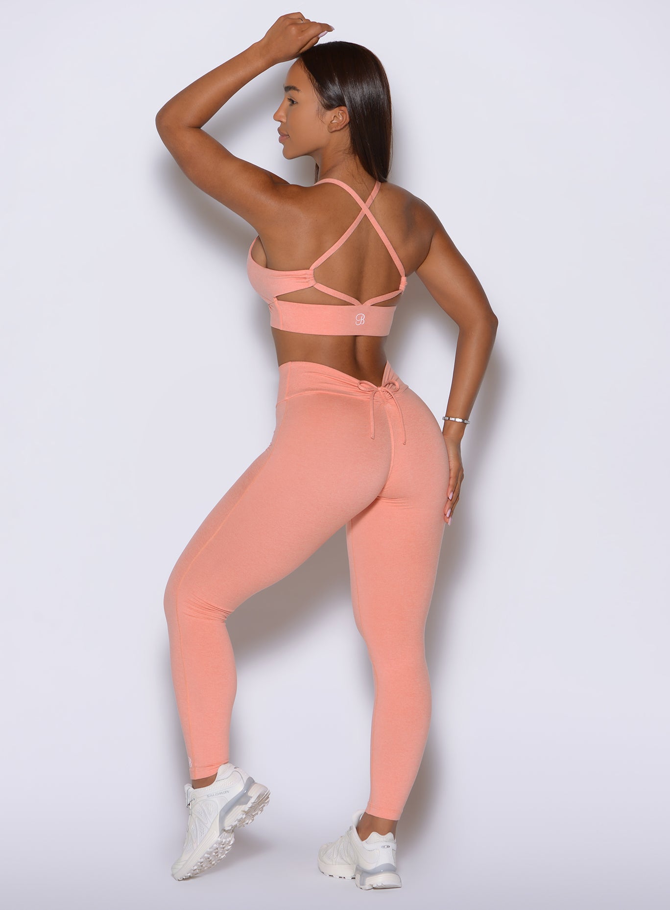 Curve enhancing seams and internal scrunch define these Coral Peach tights from behind.