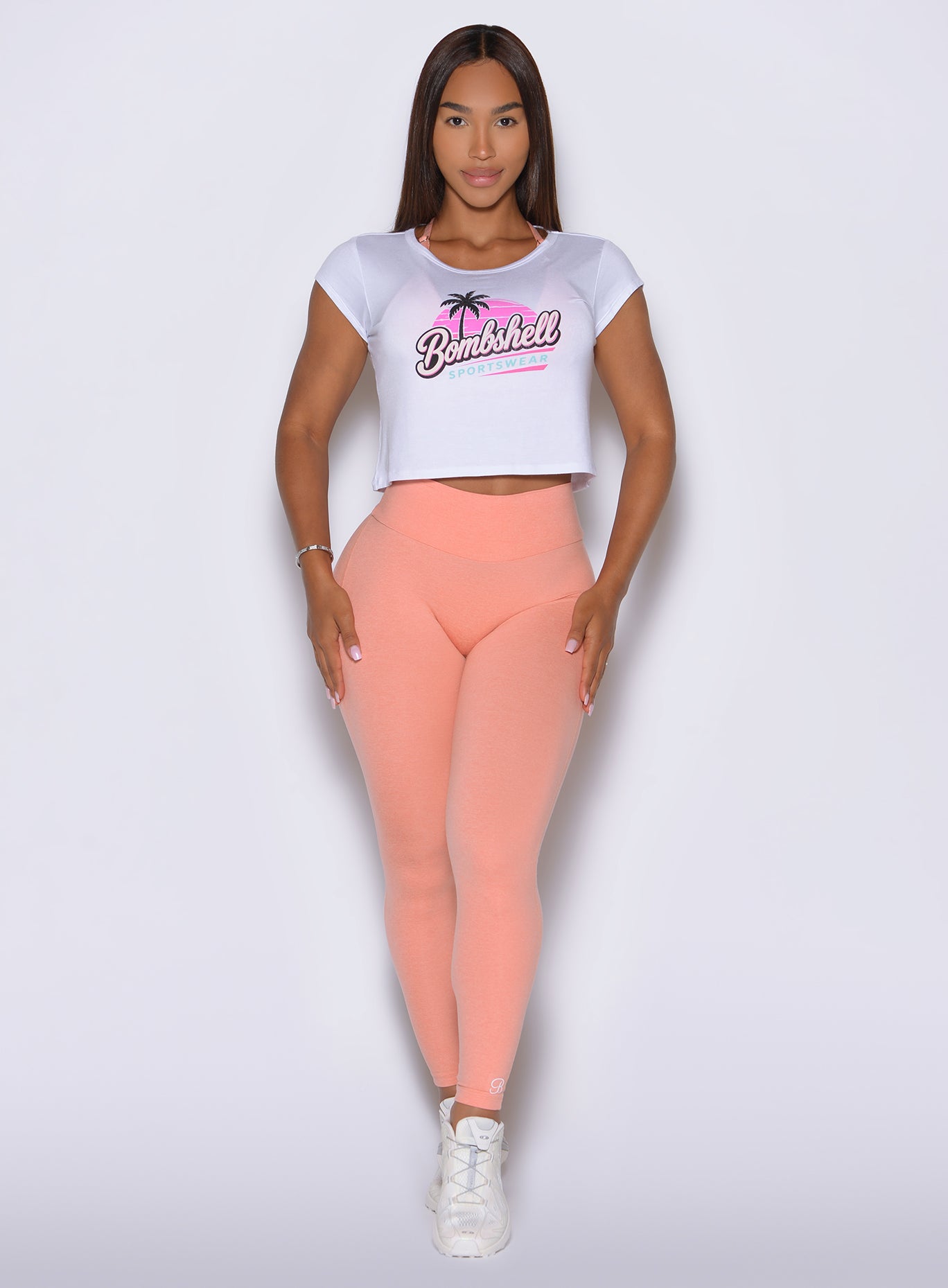 Squat proof Coral Peach gym leggings smooth and sculpt the core with a wide waistband.