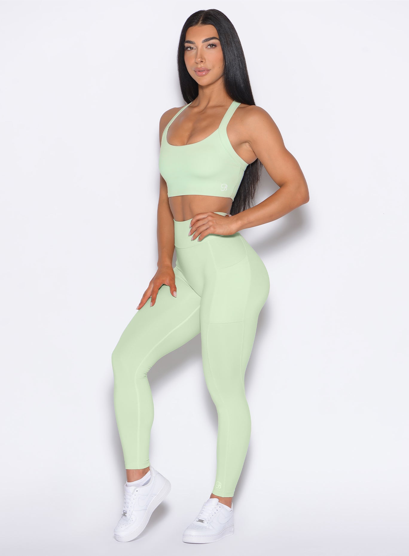 front left side profile view of our model wearing the Curves 2.0 Leggings in Cool Matcha color