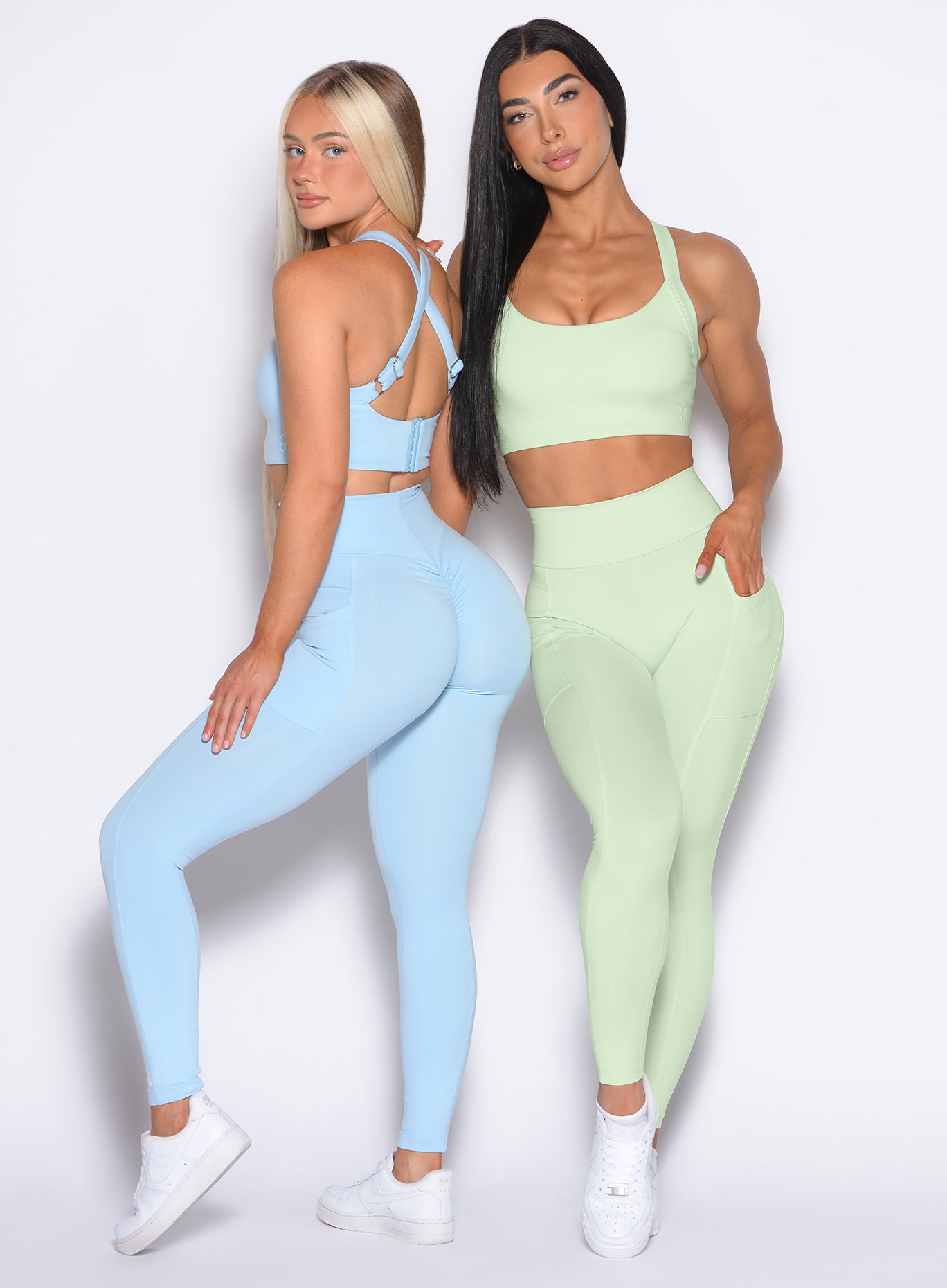 Front profile view of our model wearing the Curves 2.0 Leggings in Cool Matcha color paired with another model who is wearing the Curves 2.0 Leggings in Glacial Blue color
