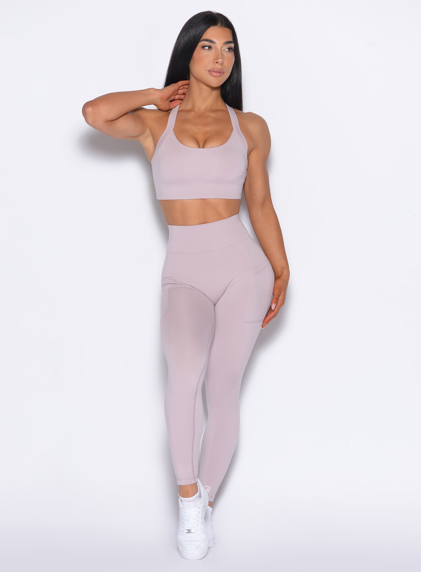 front profile view of our model looking to the left wearing the Curves 2.0 Leggings in Violet Ice color