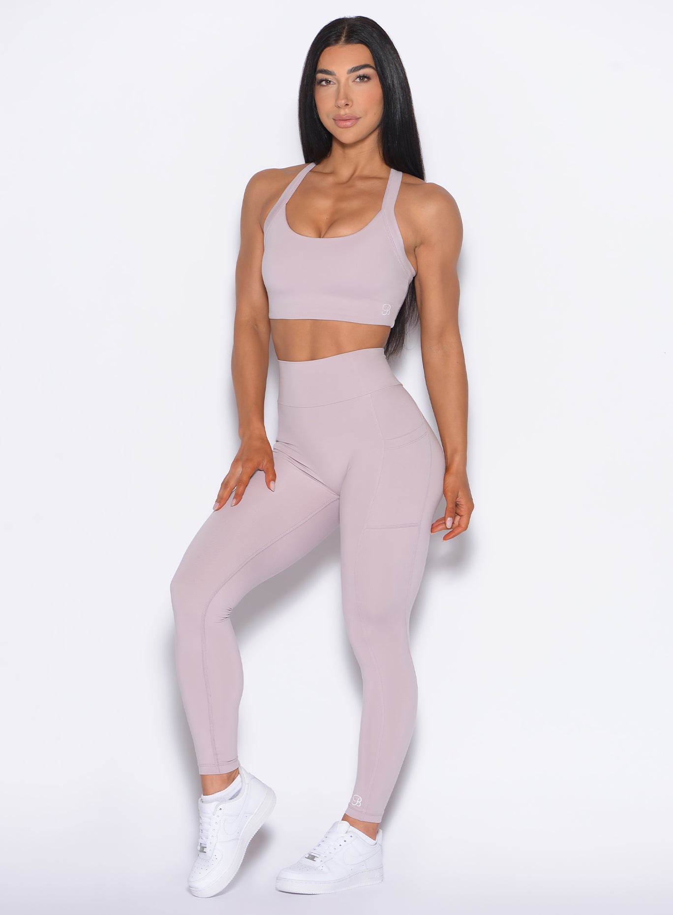 front profile view of our model with one hand hand on her thigh wearing the Curves 2.0 Leggings in Violet Ice color