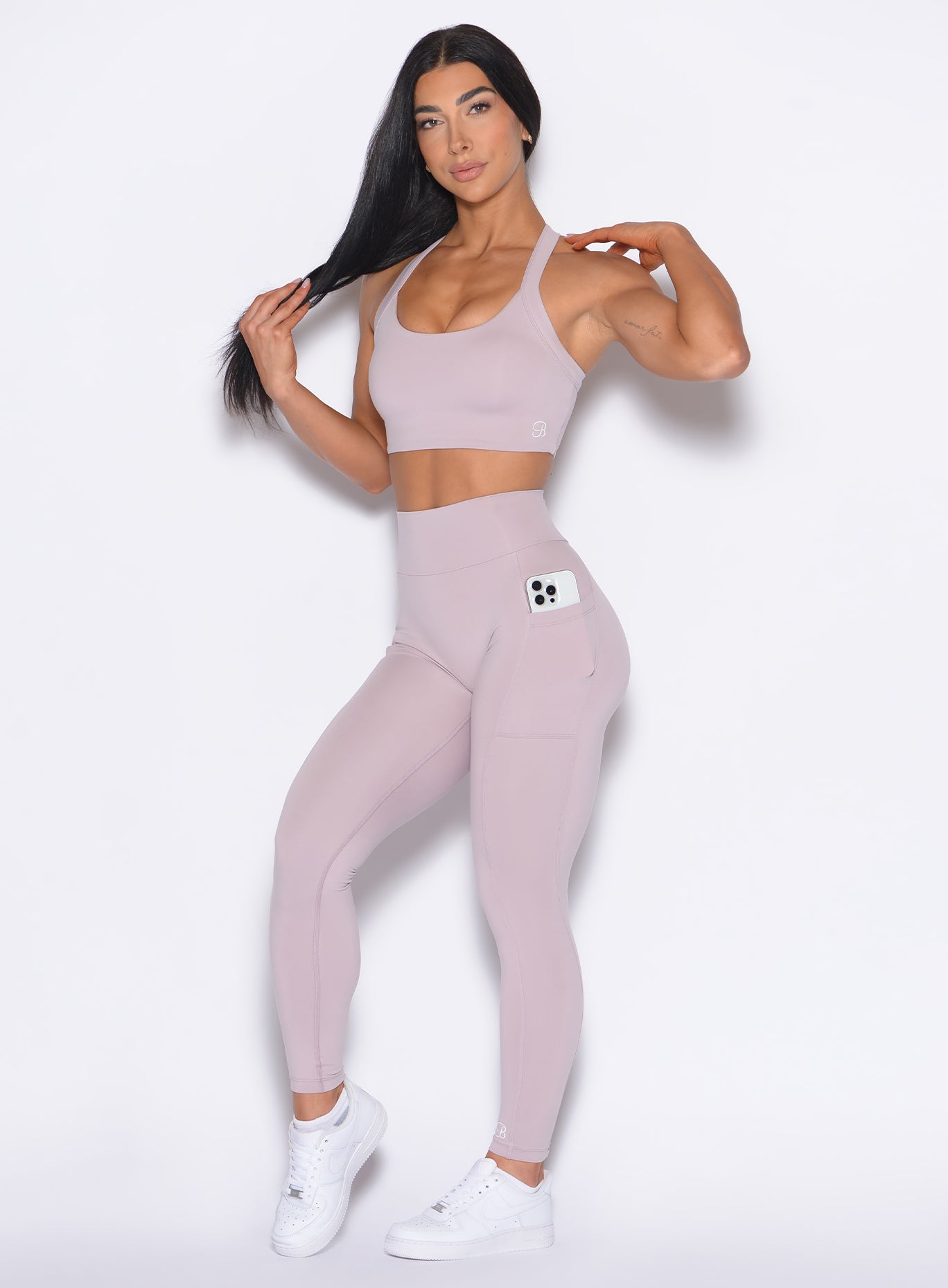 front profile view of our model wearing the Curves 2.0 Leggings in Violet Ice color paired with the matching top
