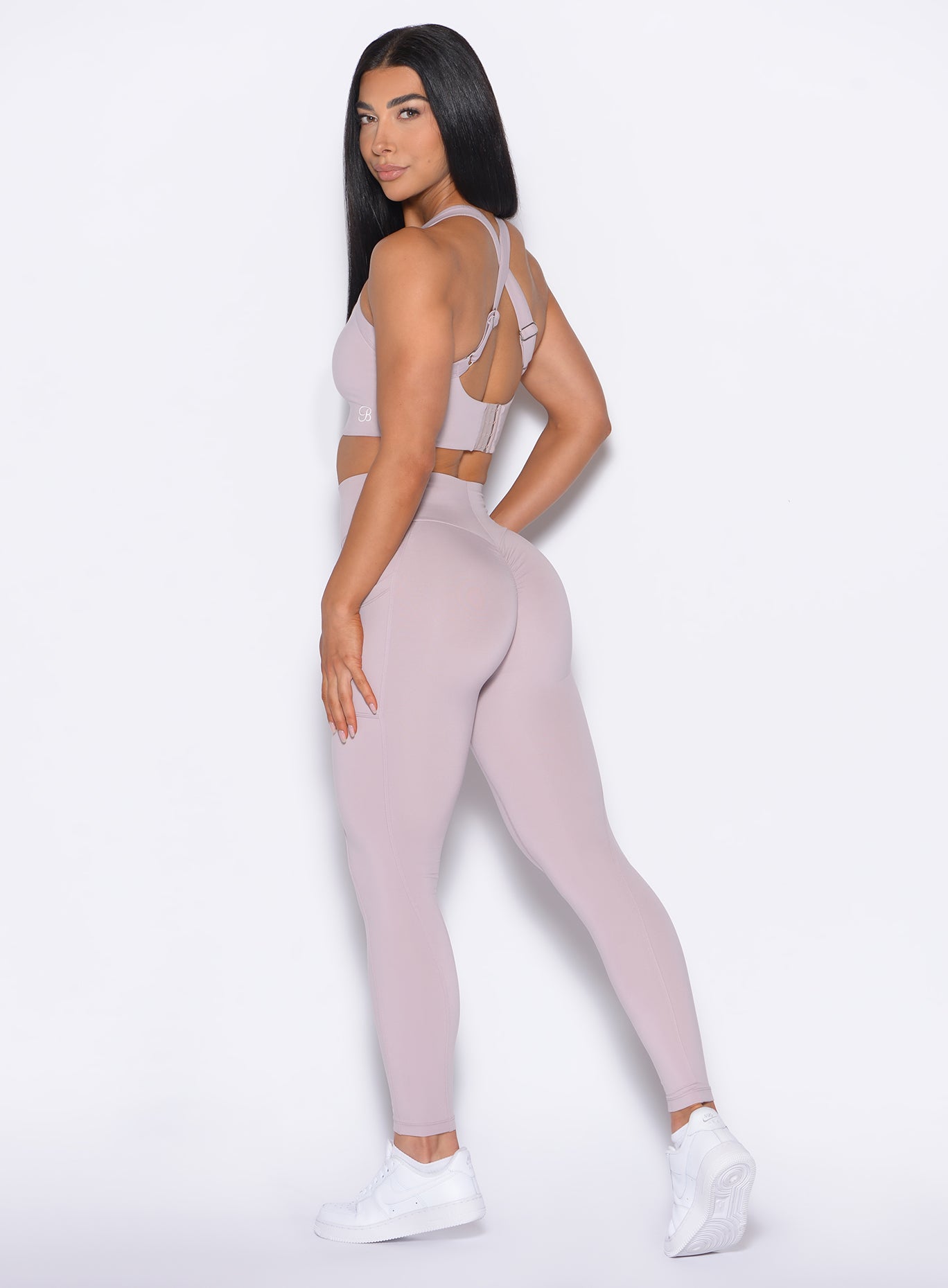 left side profile view of our model wearing the Curves 2.0 Leggings in Violet Ice color