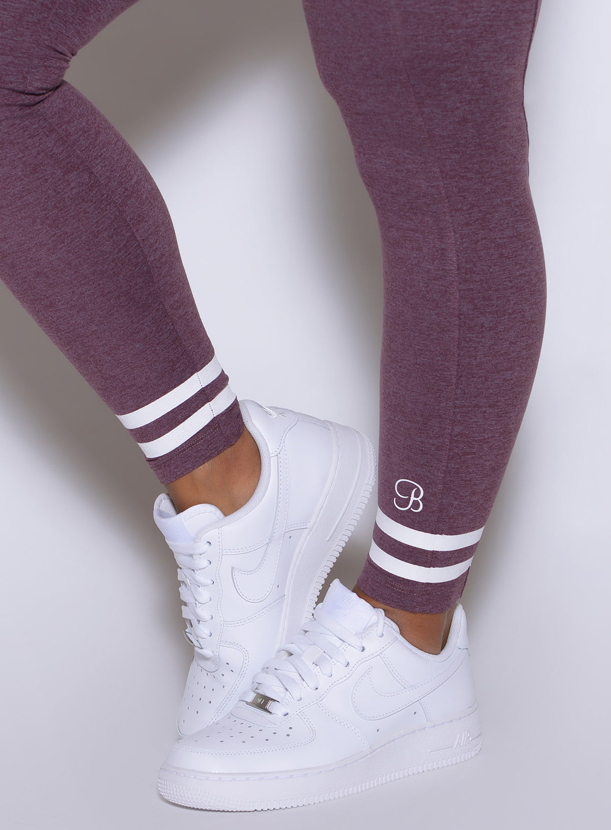 Regal Purple Curves Crew Leggings feature signature two-stripe cuffs and white sneakers.