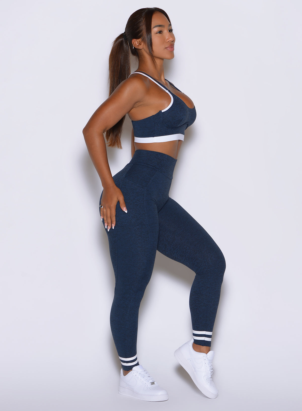 Profile perspective highlighting body-contouring seams and moisture-wicking stretch fabric.
