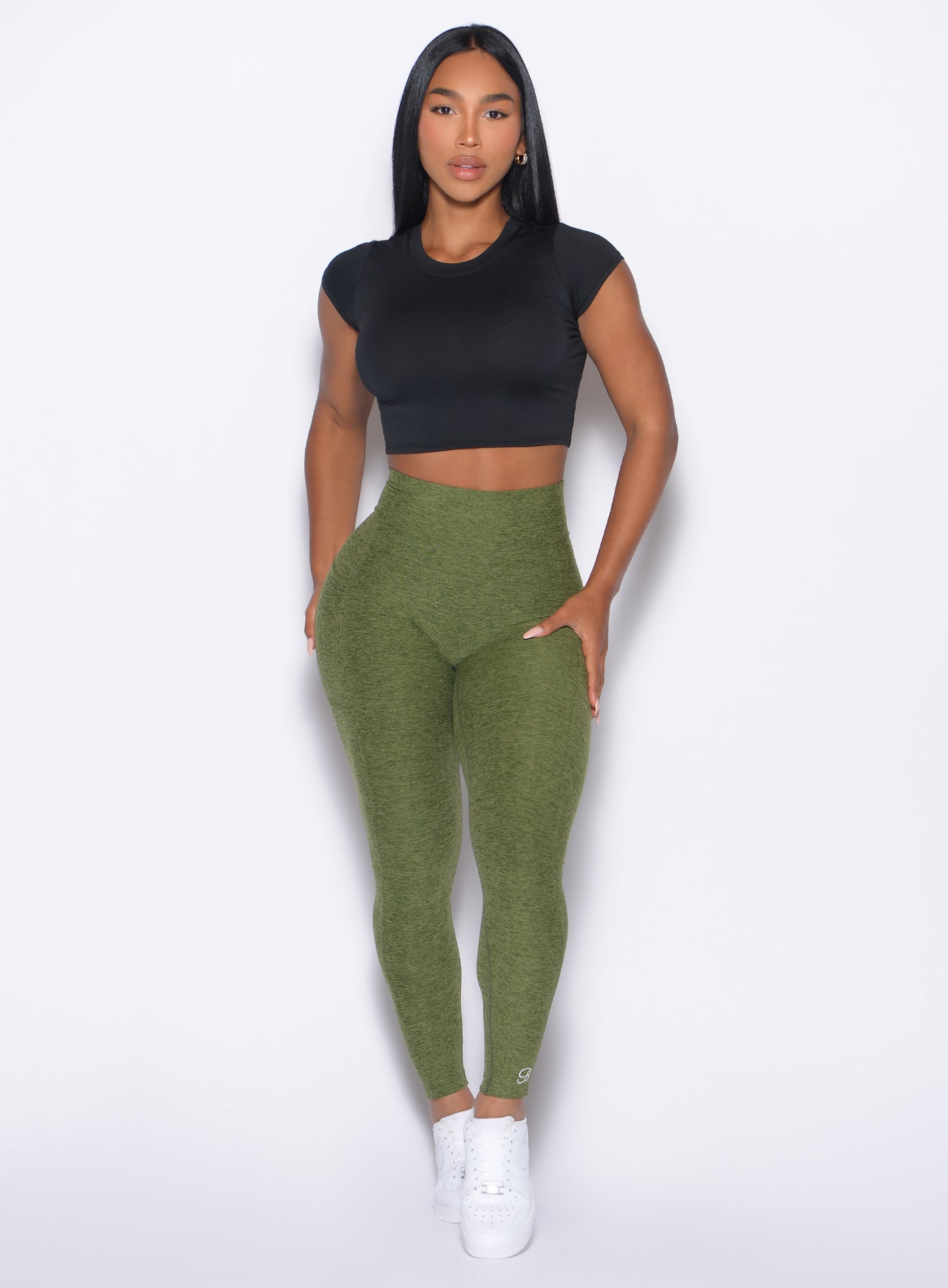 Model facing forward wearing our Flex Long Tee in Black color and the Curves 2.0 Leggings in Juniper color