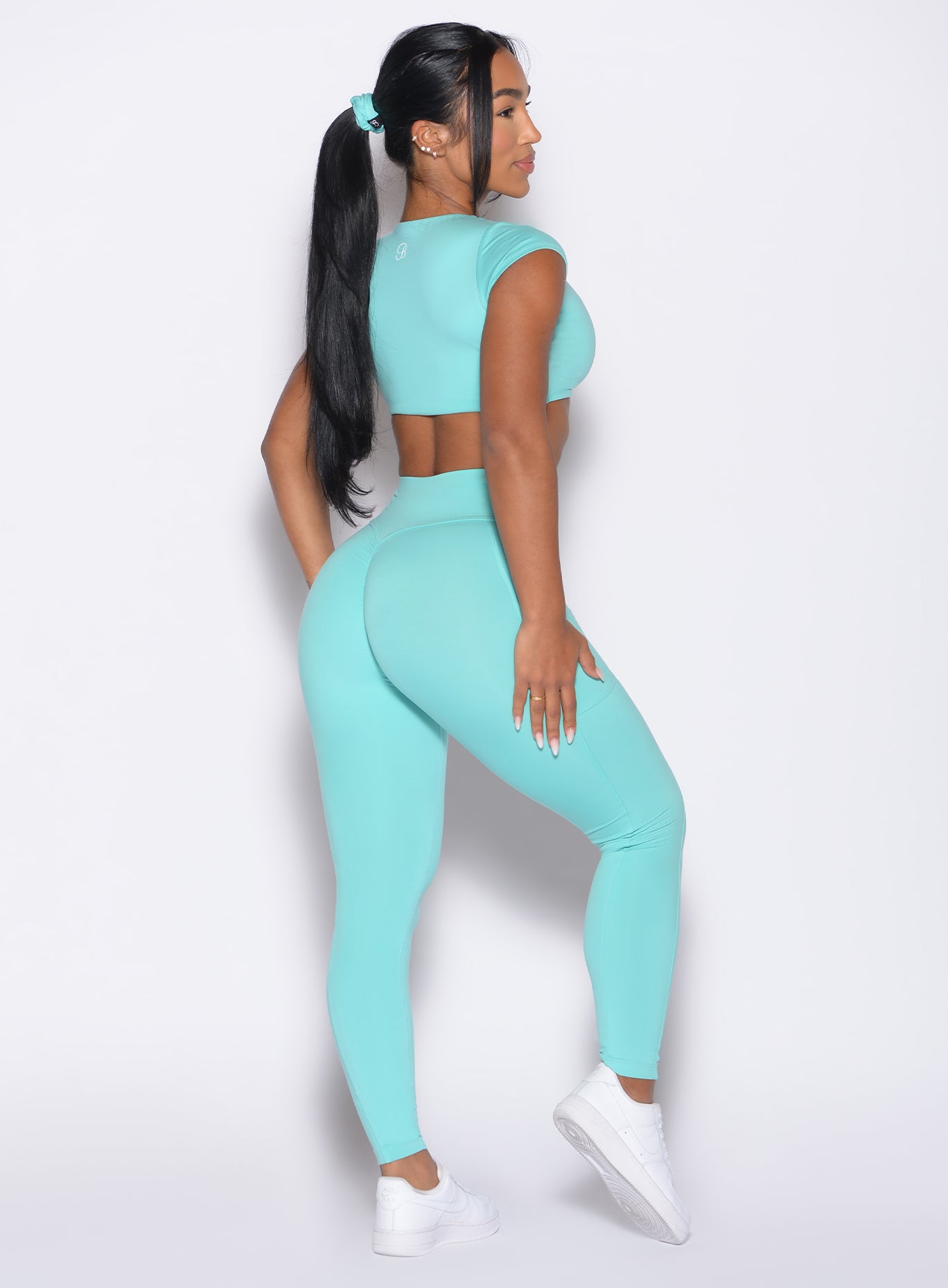 back right side profile view of a model wearing the Define Leggings in Aquatic Awe color