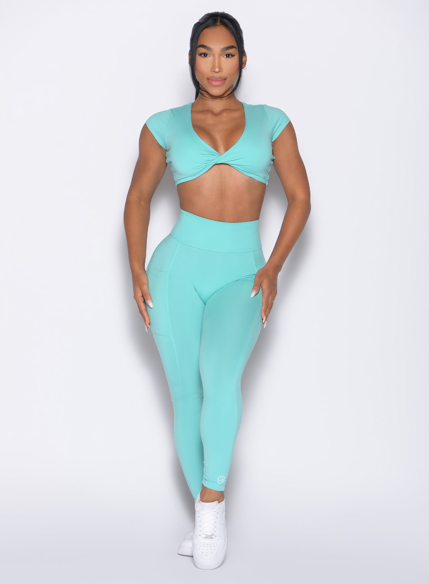front profile view of a model wearing the Define Leggings in Aquatic Awe color