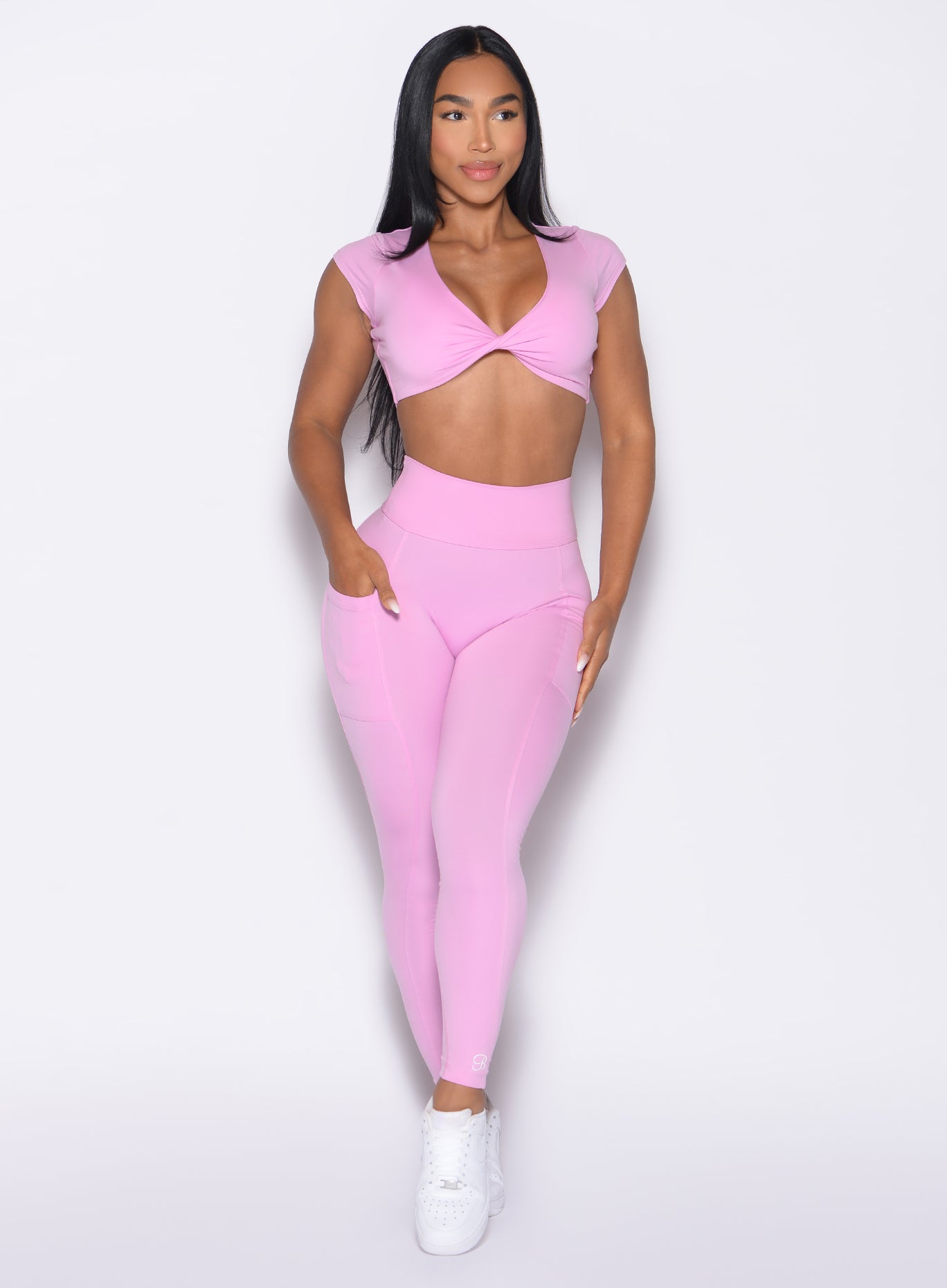 front profile view of a model with one hand inside the pocket of the leggings wearing the Define Leggings in Lilac Chiffon color