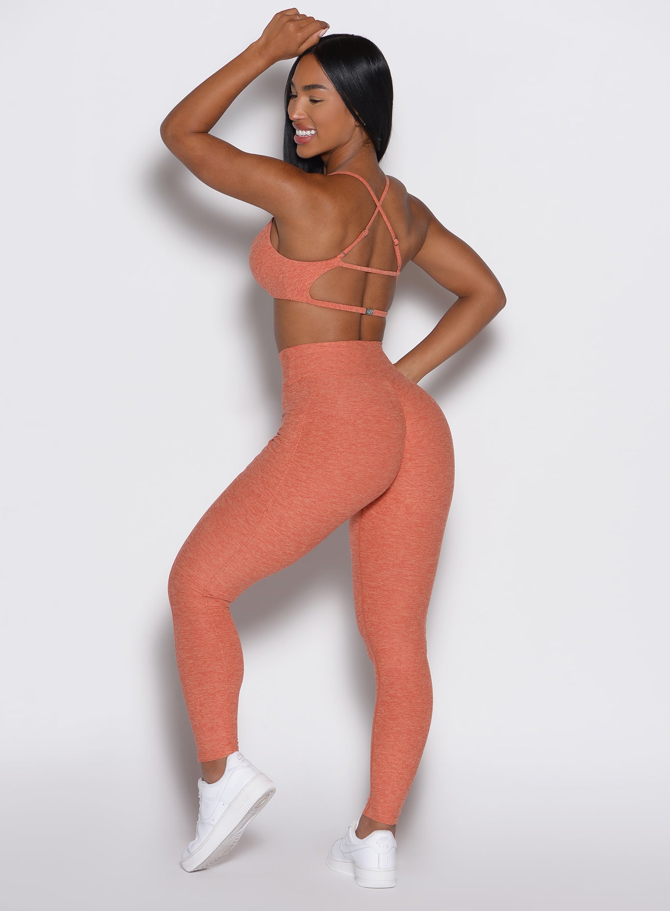 back profile view of a model wearing the Define Leggings in Spiced Maple color