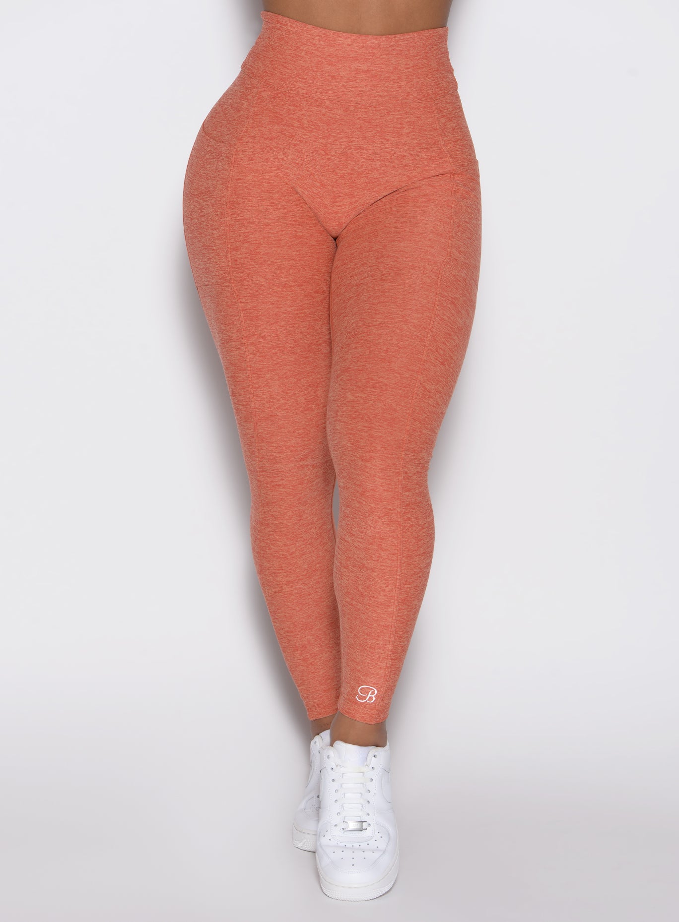 close up front view of a model wearing the Define Leggings in Spiced Maple color