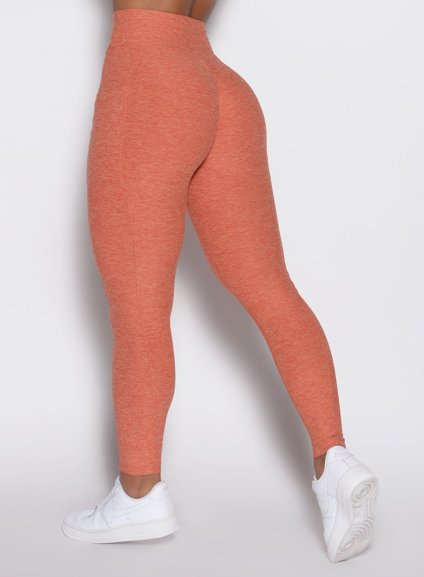 close up back left side profile view of a model wearing the Define Leggings in Spiced Maple color