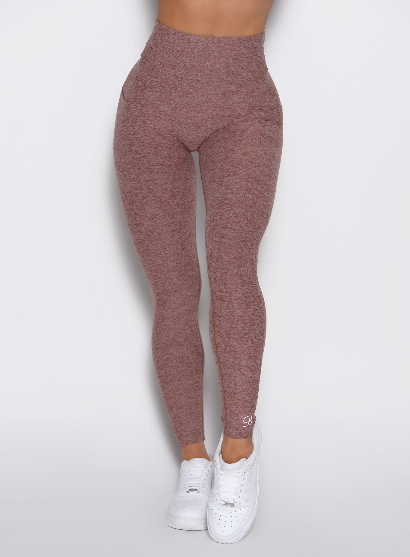 close up front view of a model wearing the Define Leggings in walnut color
