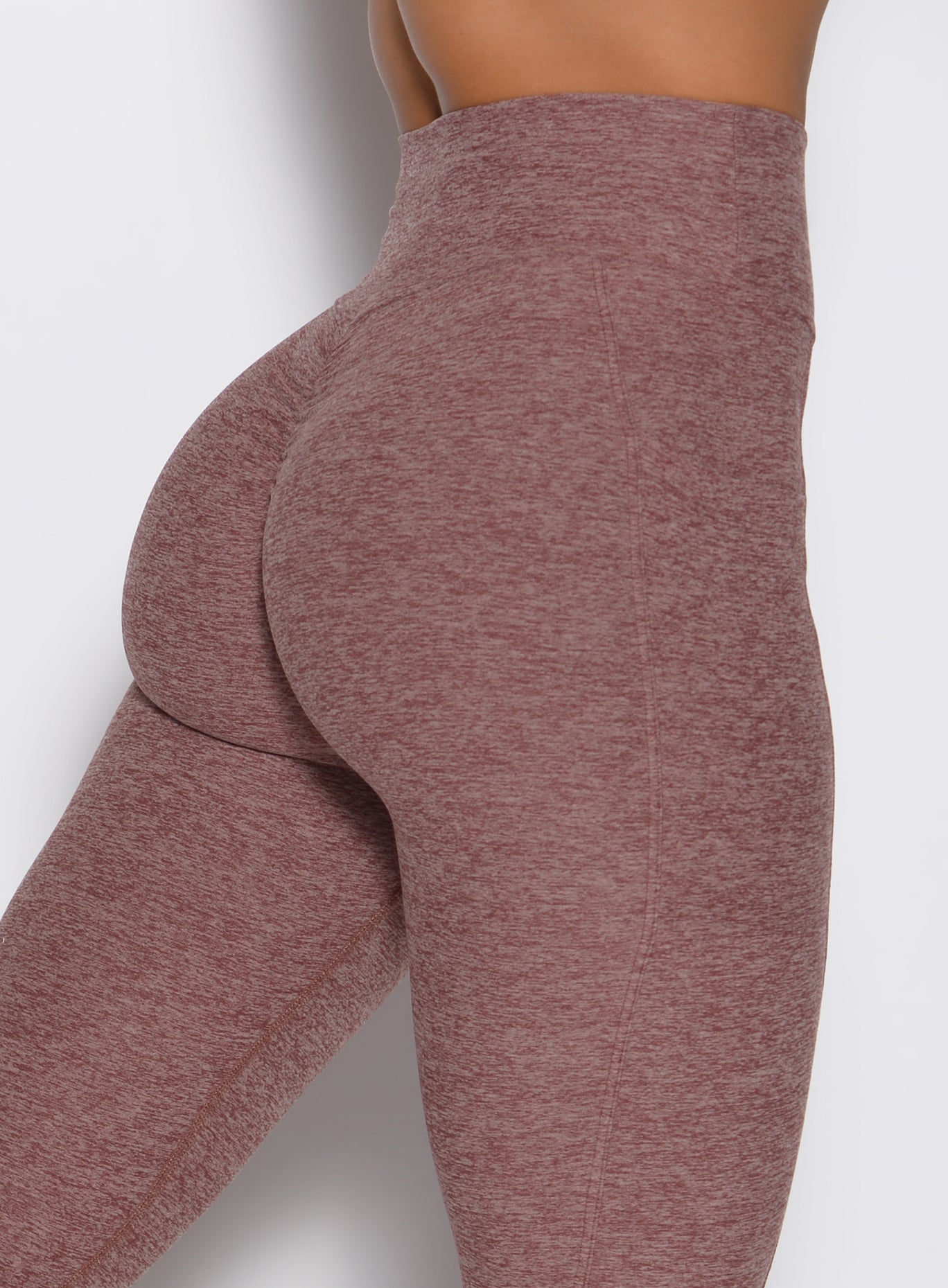 zoomed in back right side profile view of a model wearing the Define Leggings in walnut color
