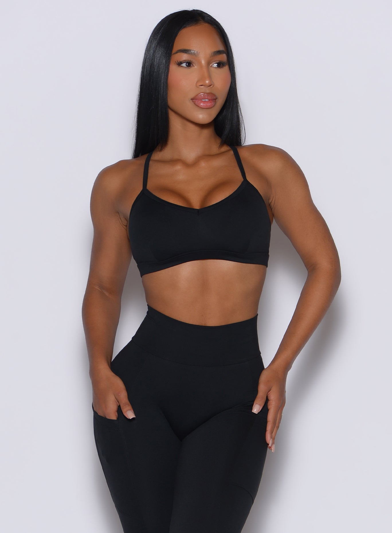Front profile of a model wearing our black diamond sports bra and a matching leggings