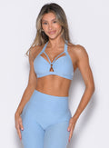 front profile view of a model wearing the Iron Edge Bra in Blue Mist color paired with the matching leggings