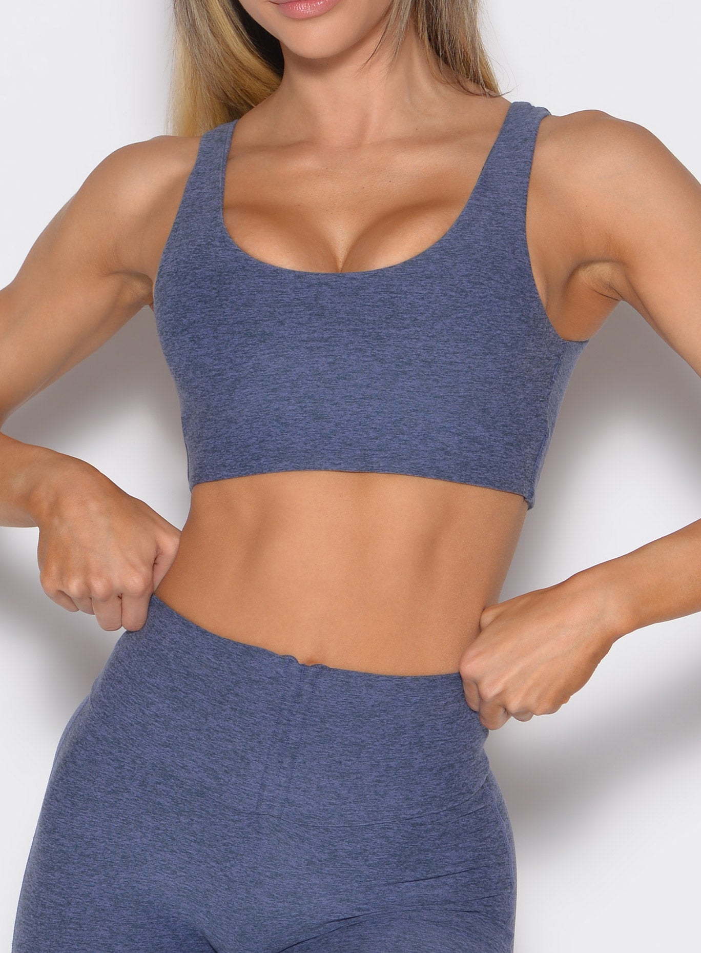 front profile view of a model wearing the Dualmode bra in wisteria blue color without the logo in front