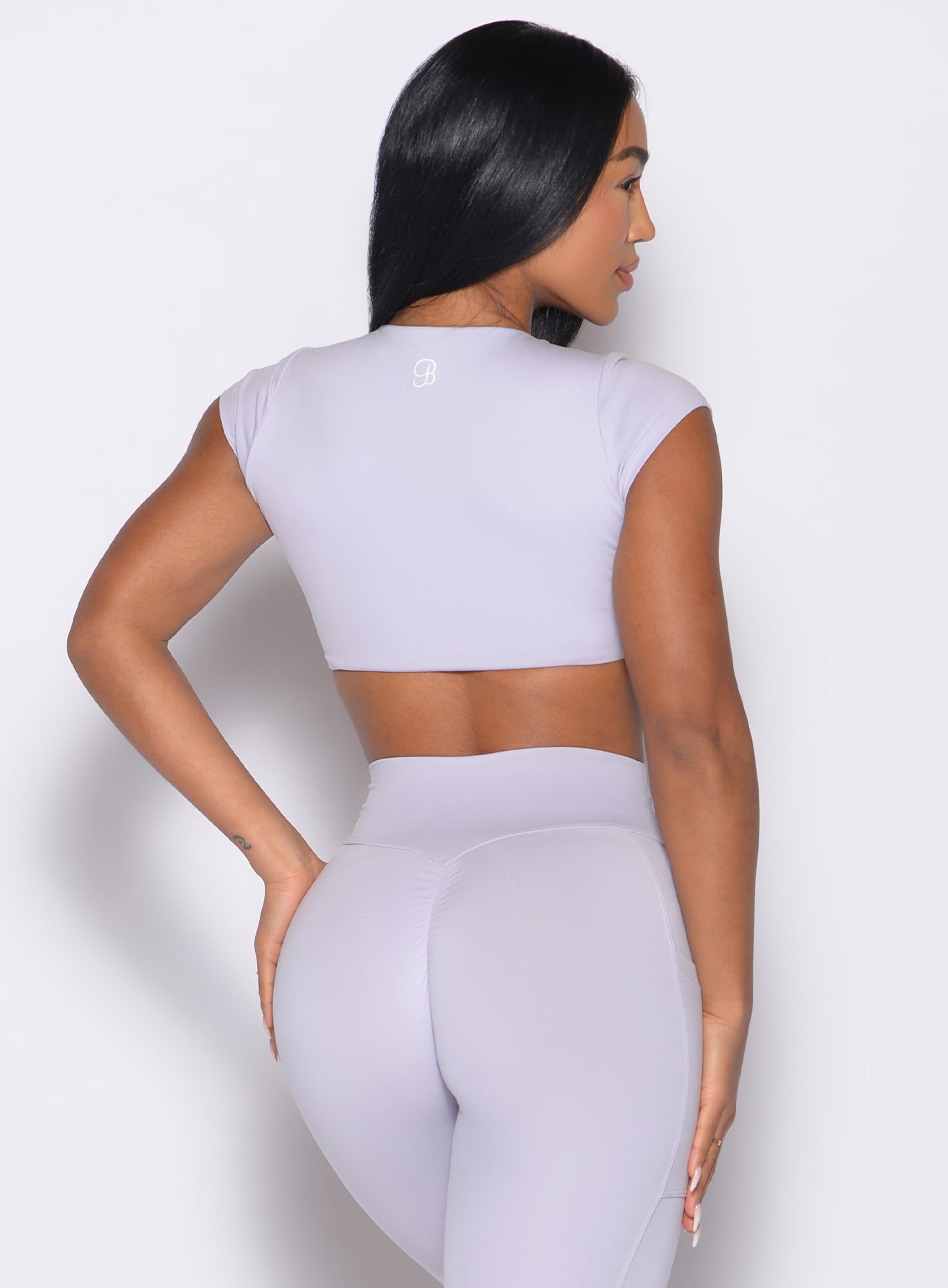back profile view of a model wearing the Fab Bust Bra in galactic lilac color