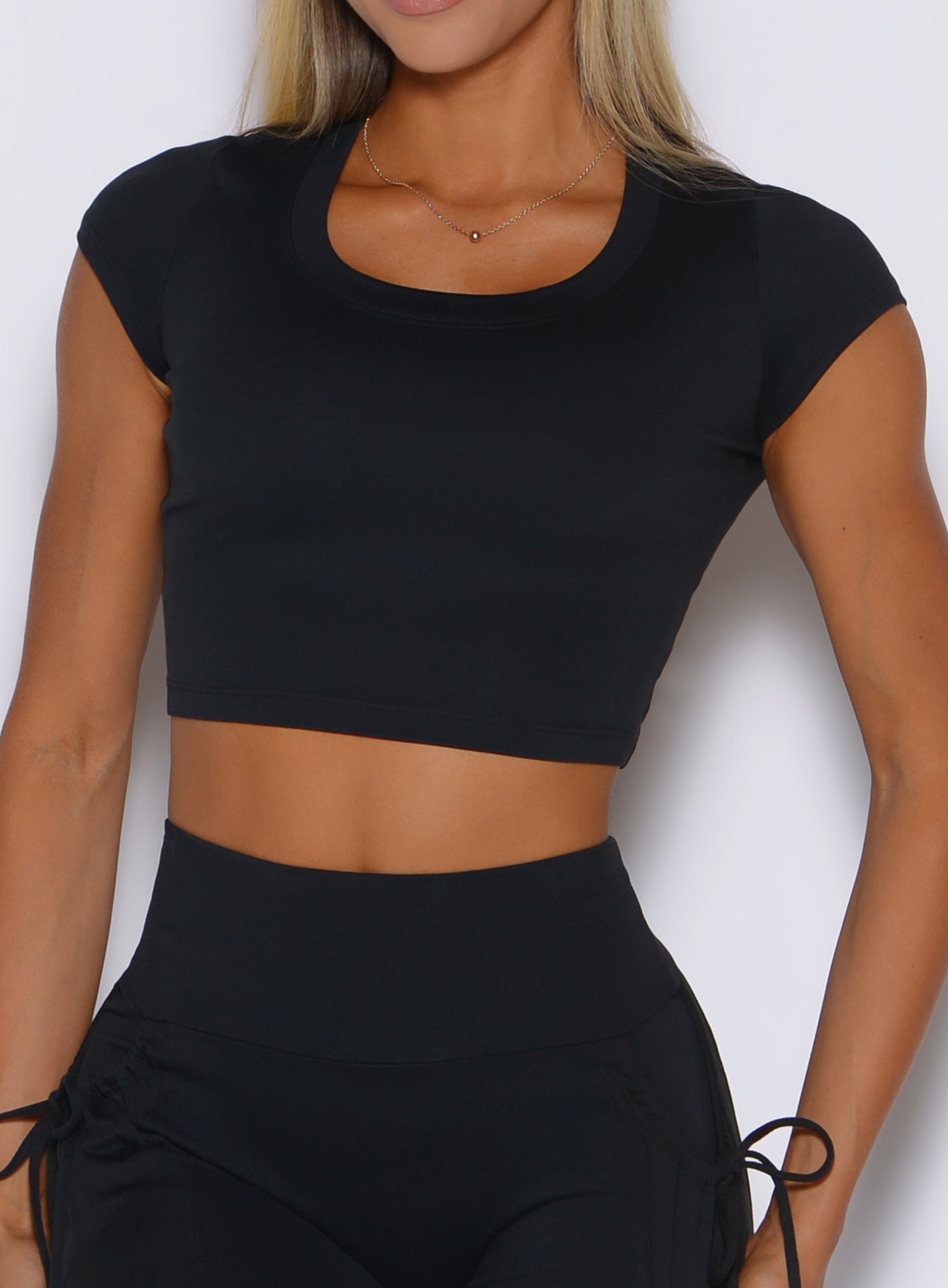 close up front view of a model wearing the FitBoost Tee in Black color