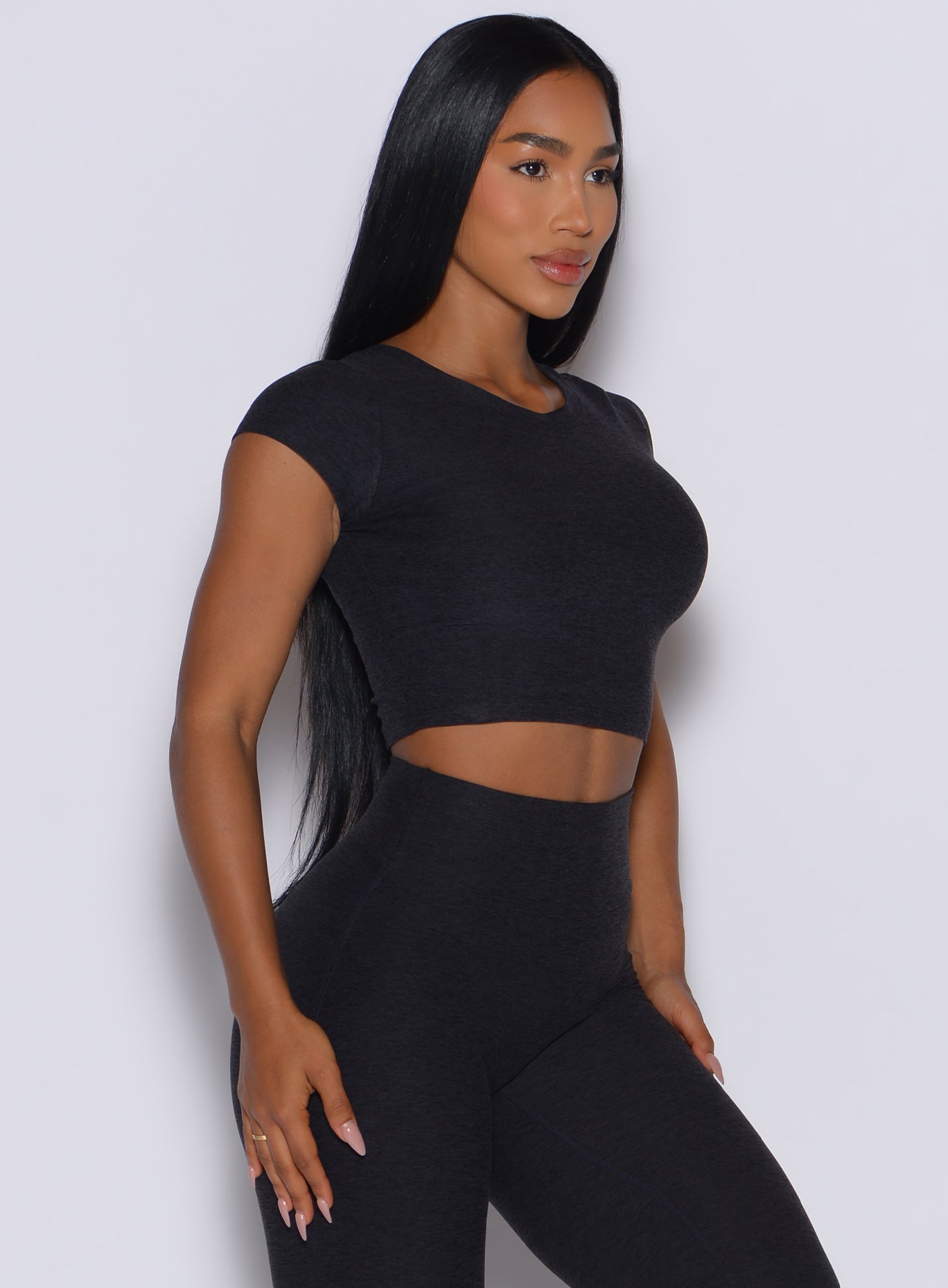 Onyx Fit Fam Active Tee featuring heathered black fabric, cap sleeves, and a cropped gym fit.