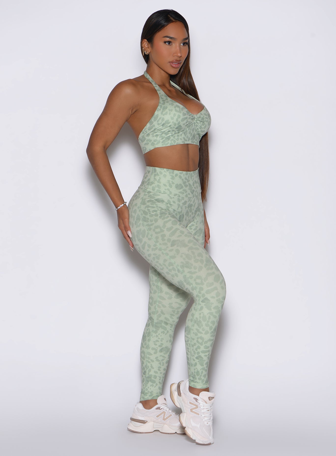 Right profile shot of the model in our Flexfit Leggings, Leopard Cool Matcha, with her left hand on her hip.