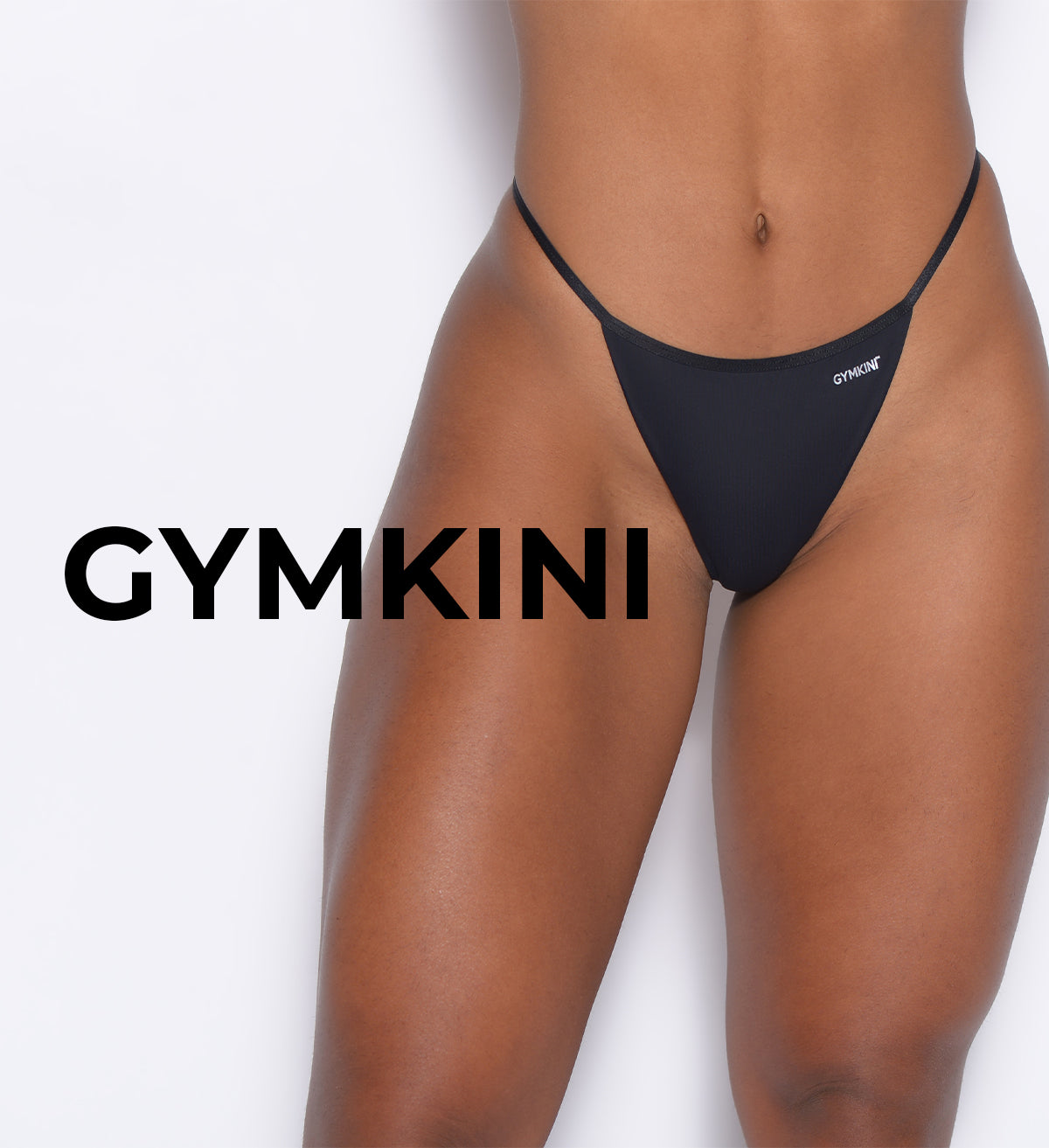 A close-up of a models lower body wearing a black bikini bottom, with the word GYMKINI displayed prominently next to the image